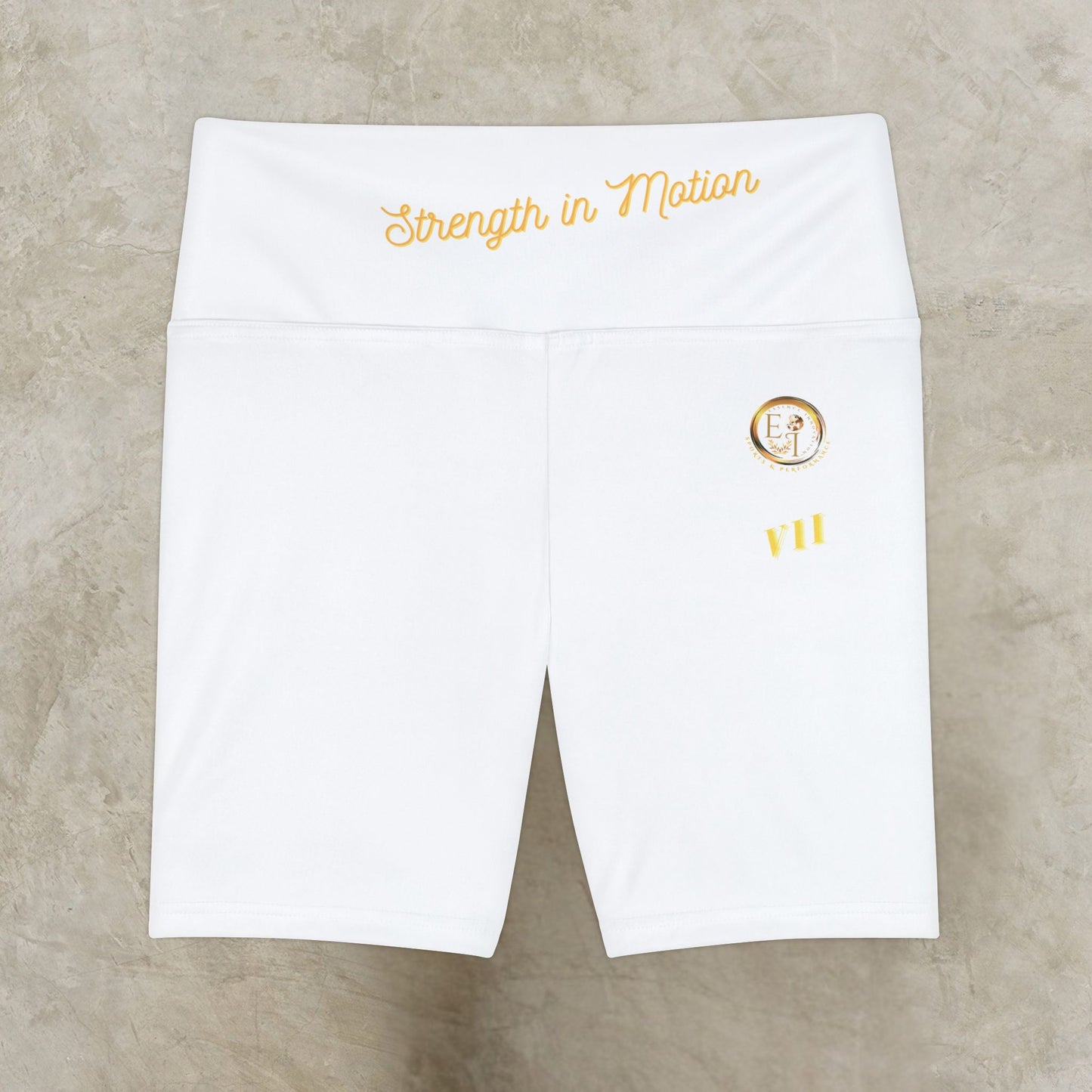 White athletic shorts with 'Strength in Motion' text and logo on a beige background