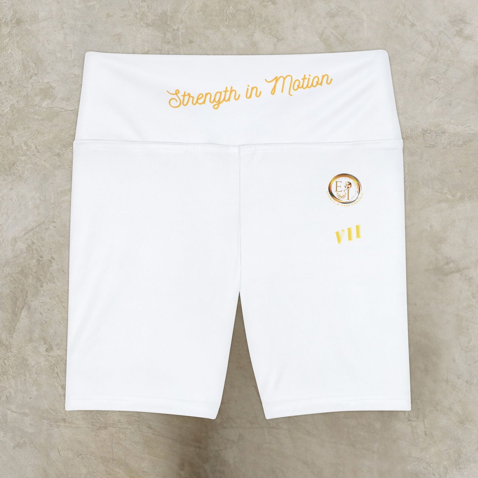 White athletic shorts with 'Strength in Motion' text and logo on a beige background