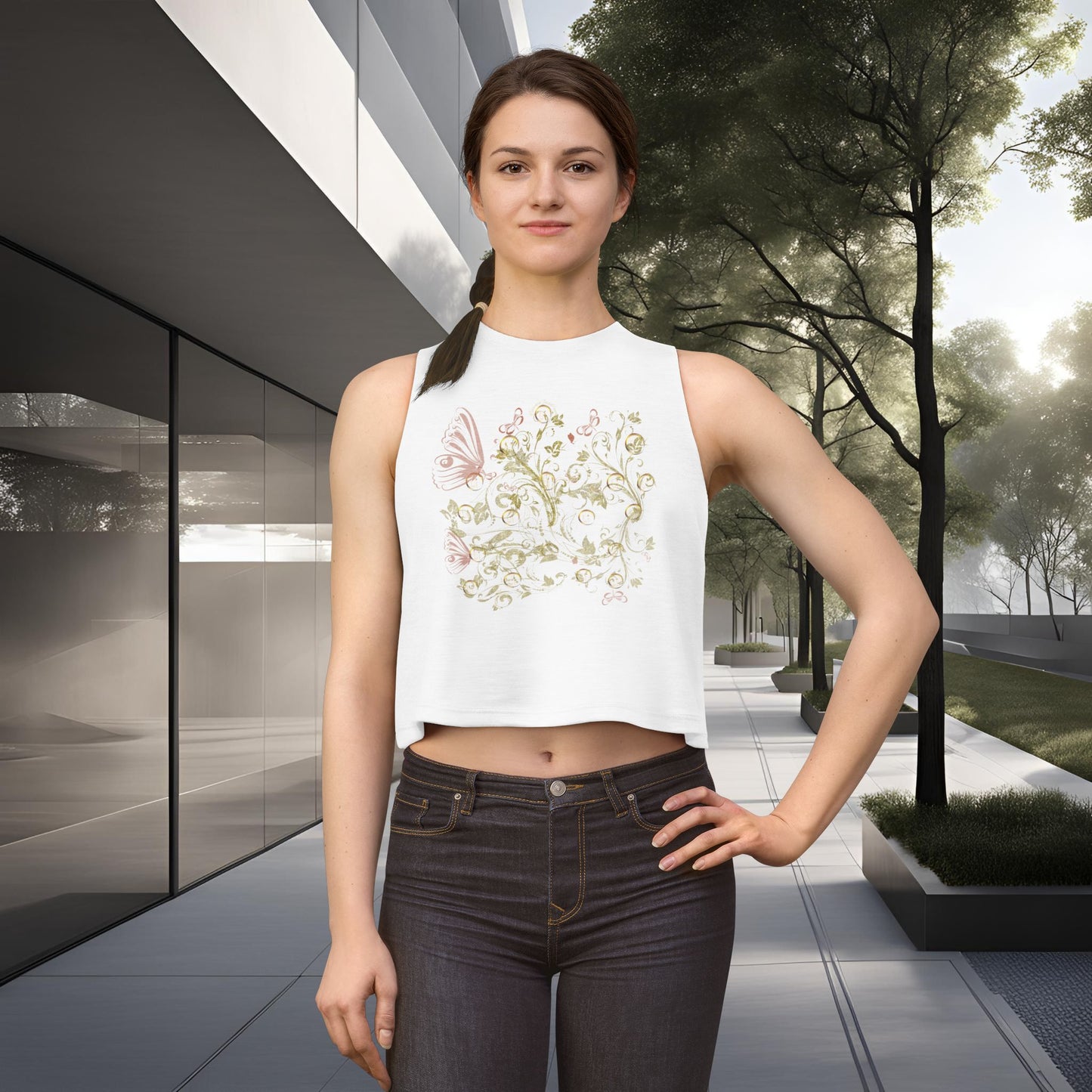 Woman wearing a white sleeveless top with Essence Innovation Bohemian Butterfly floral design and dark jeans standing in an urban setting.