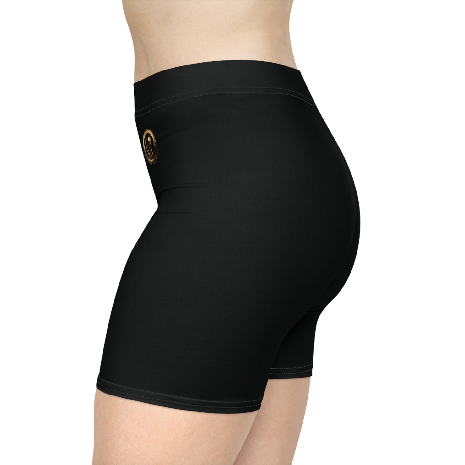 Black athletic shorts with gold text on a white background