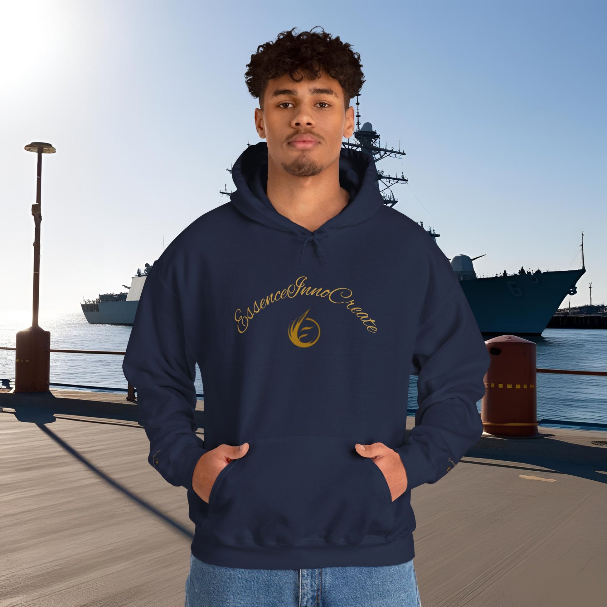 Person wearing a navy hoodie with 'EssenceInnoCreate' text and logo in front of a ship