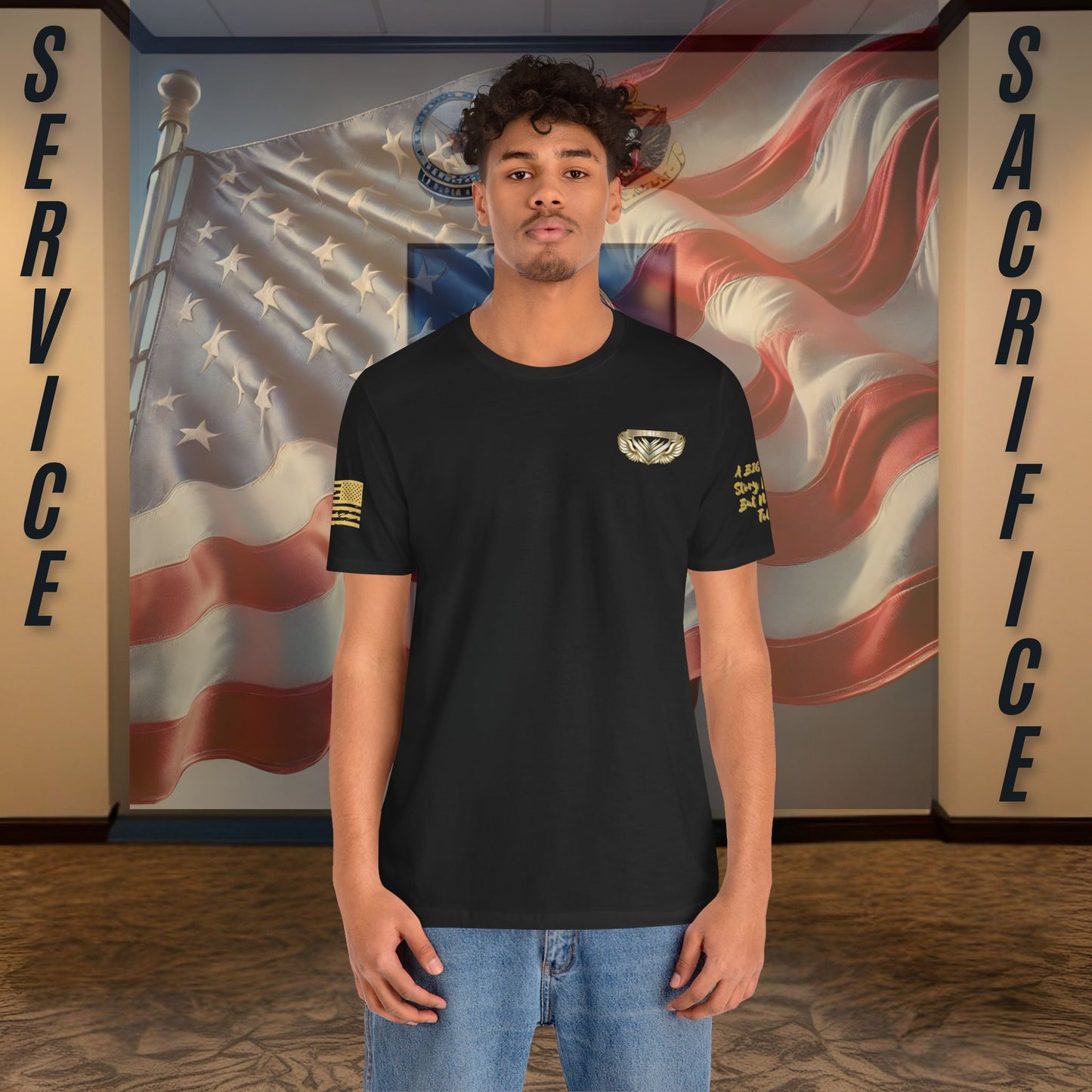 Person wearing a black t-shirt with a logo in front of an American flag and 'Service' and 'Sacrifice' text.