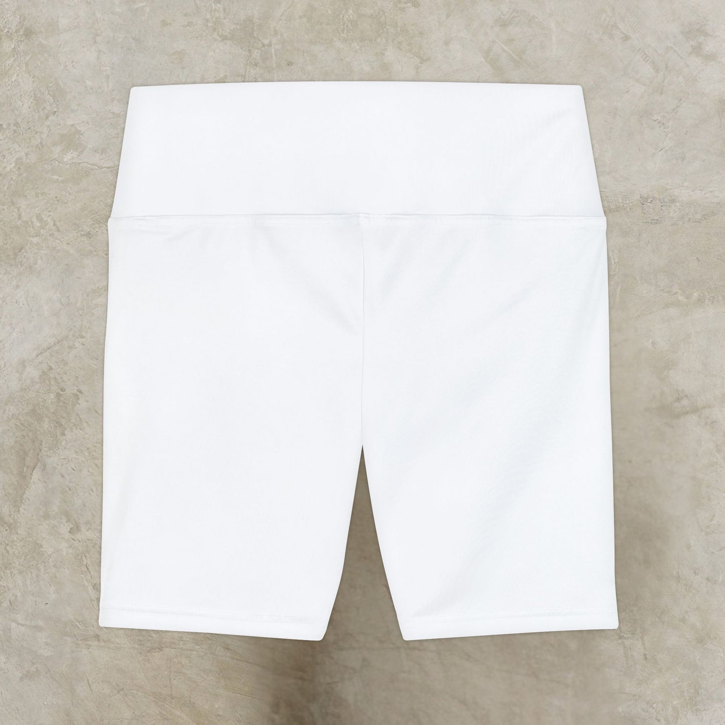White shorts on a beige textured surface