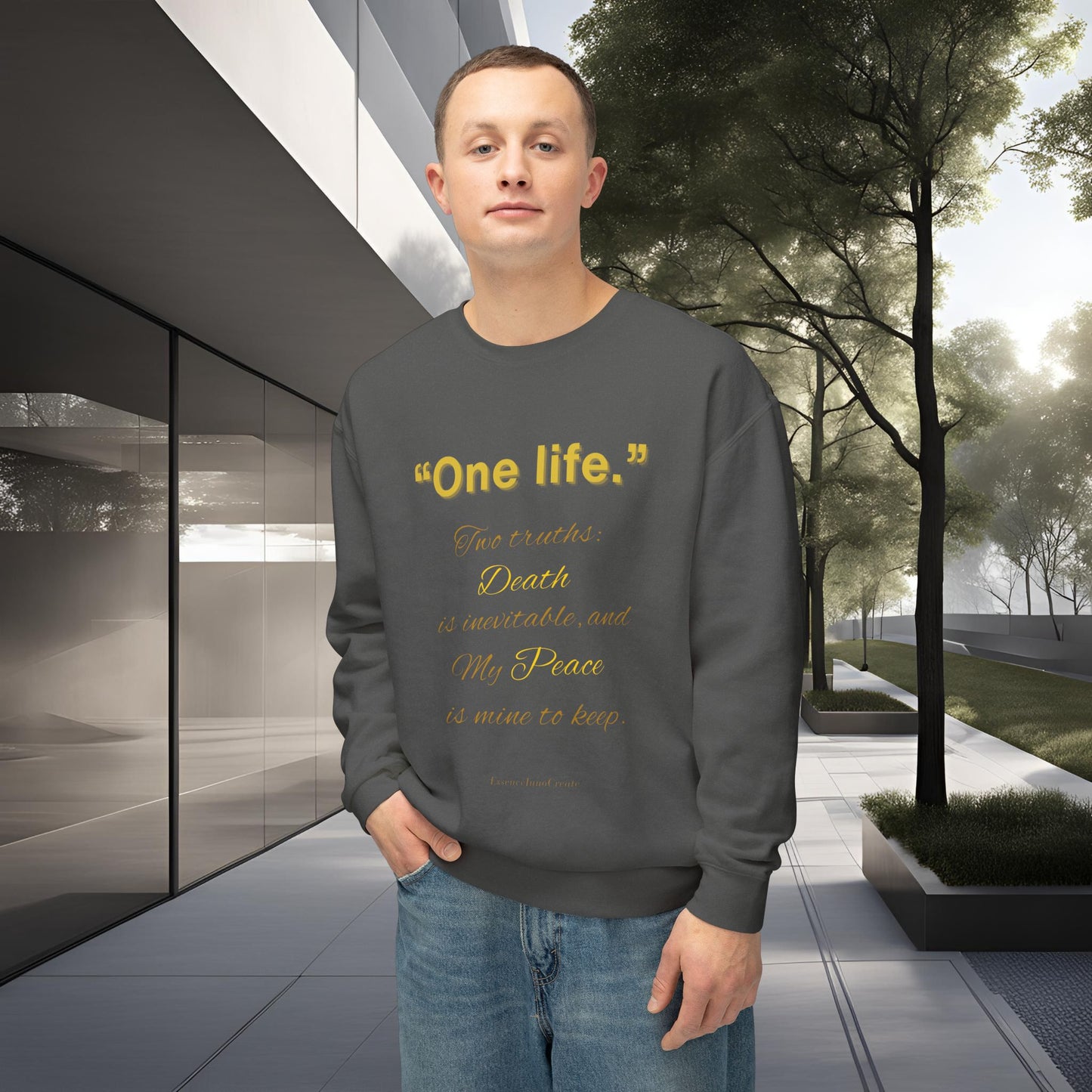 Person wearing a gray sweatshirt with One Life text in an outdoor setting