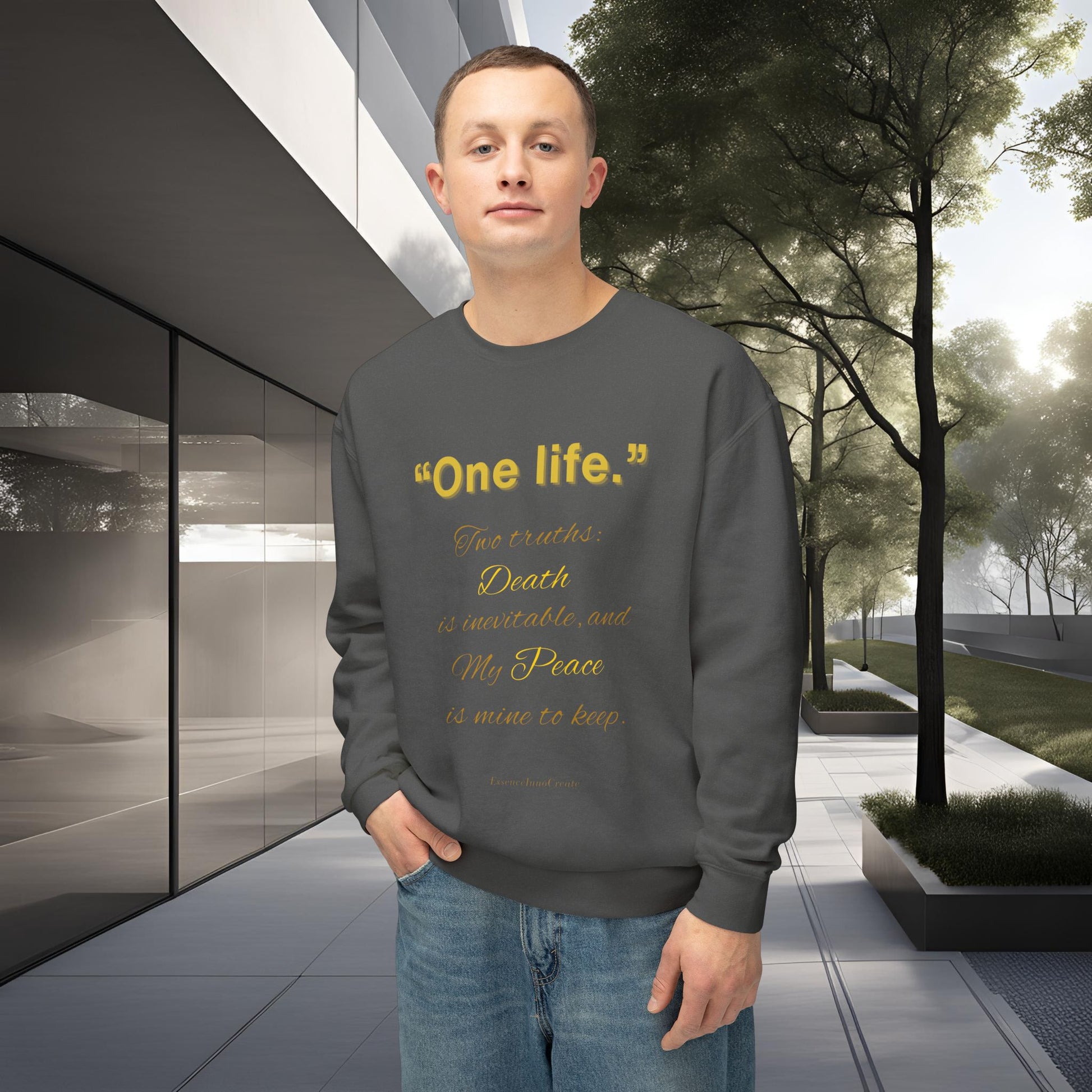 Person wearing a gray sweatshirt with One Life text in an outdoor setting