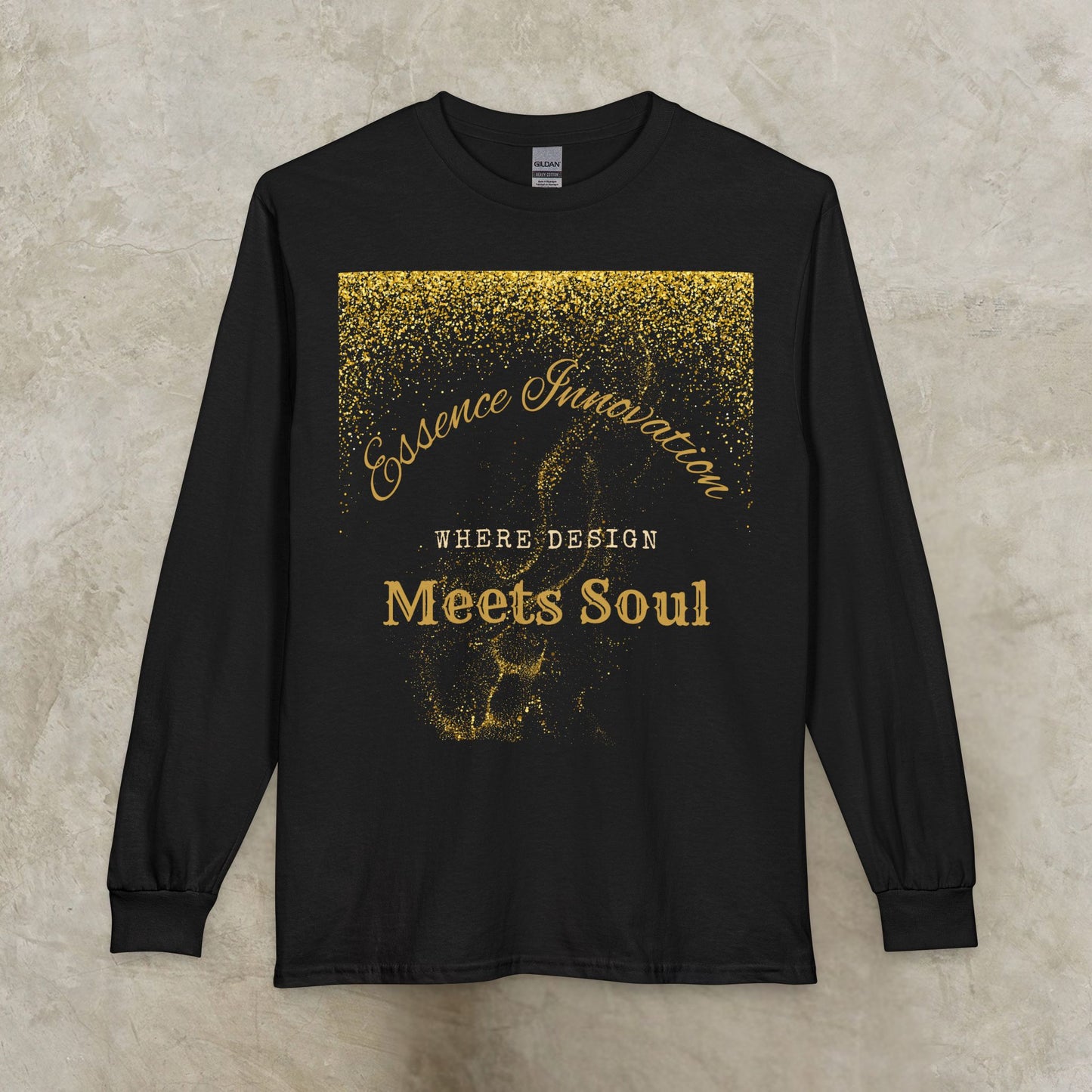 Black long-sleeve shirt with gold Essence Innovation 'Design Meets Soul' text and design on a textured beige background
