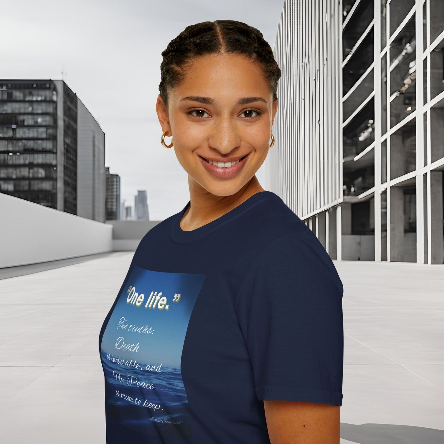 Woman wearing a navy blue 'One Life' t-shirt with a graphic design in an urban setting