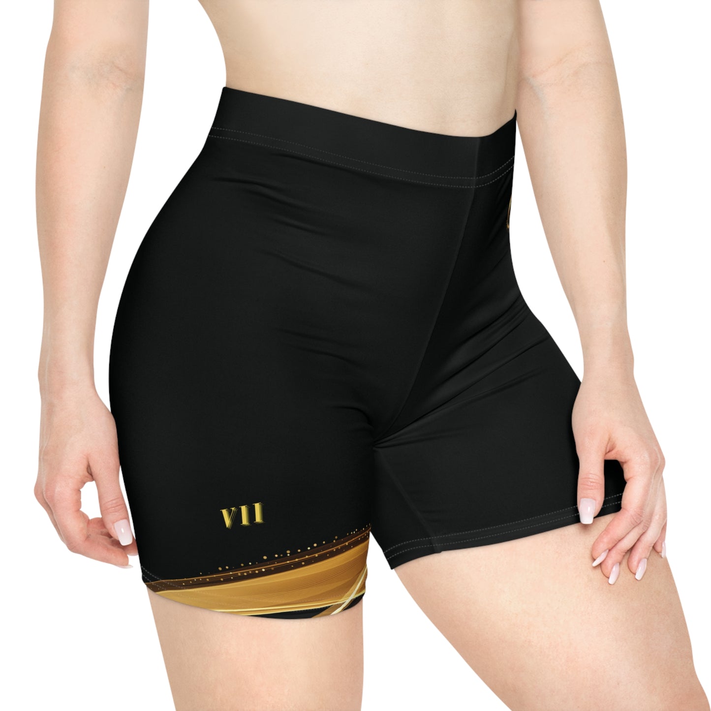 Black athletic shorts with gold design on a white background
