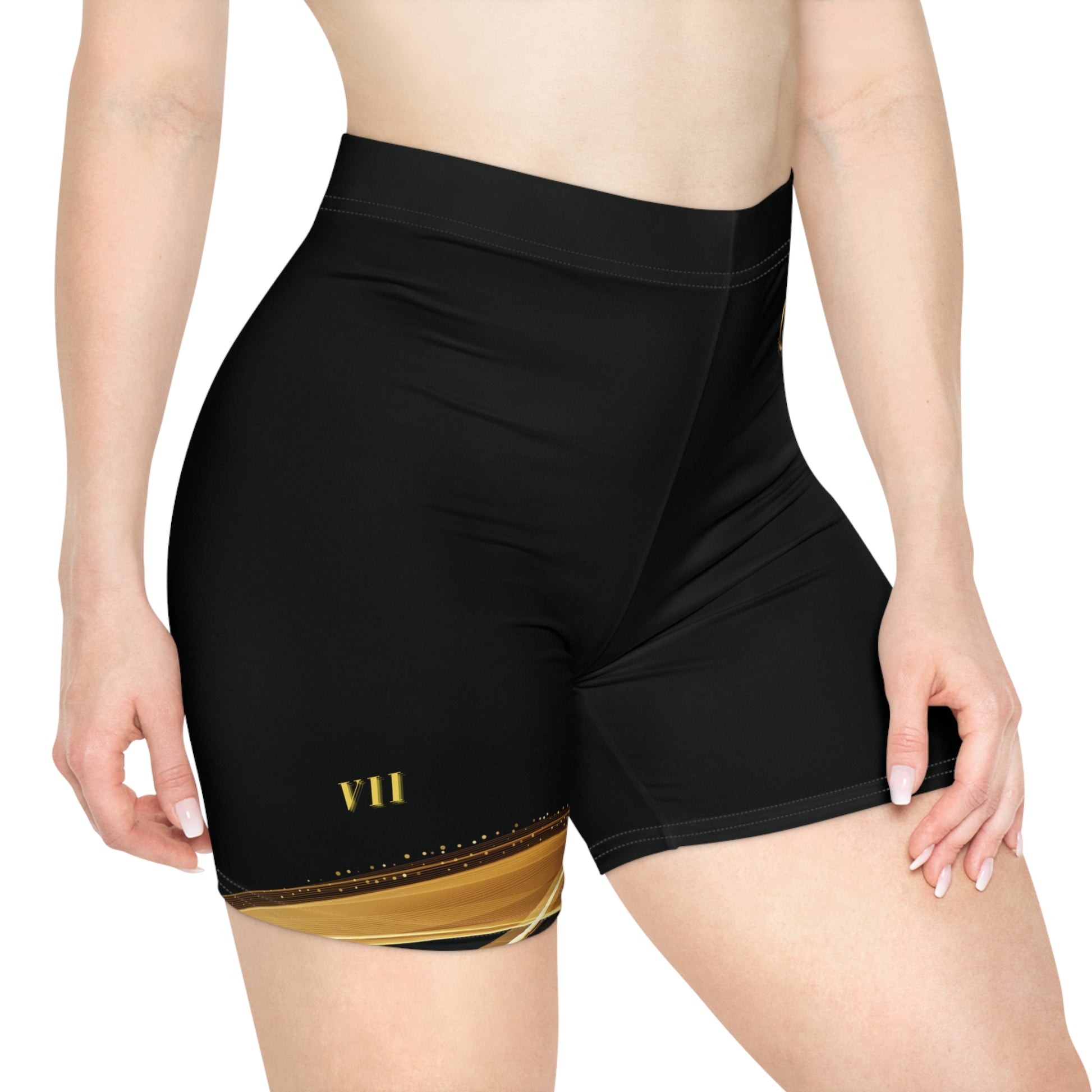 Black athletic shorts with gold design on a white background