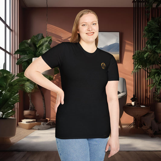 Person wearing a black t-shirt with an Essence Innovation logo in a room with plants and decor