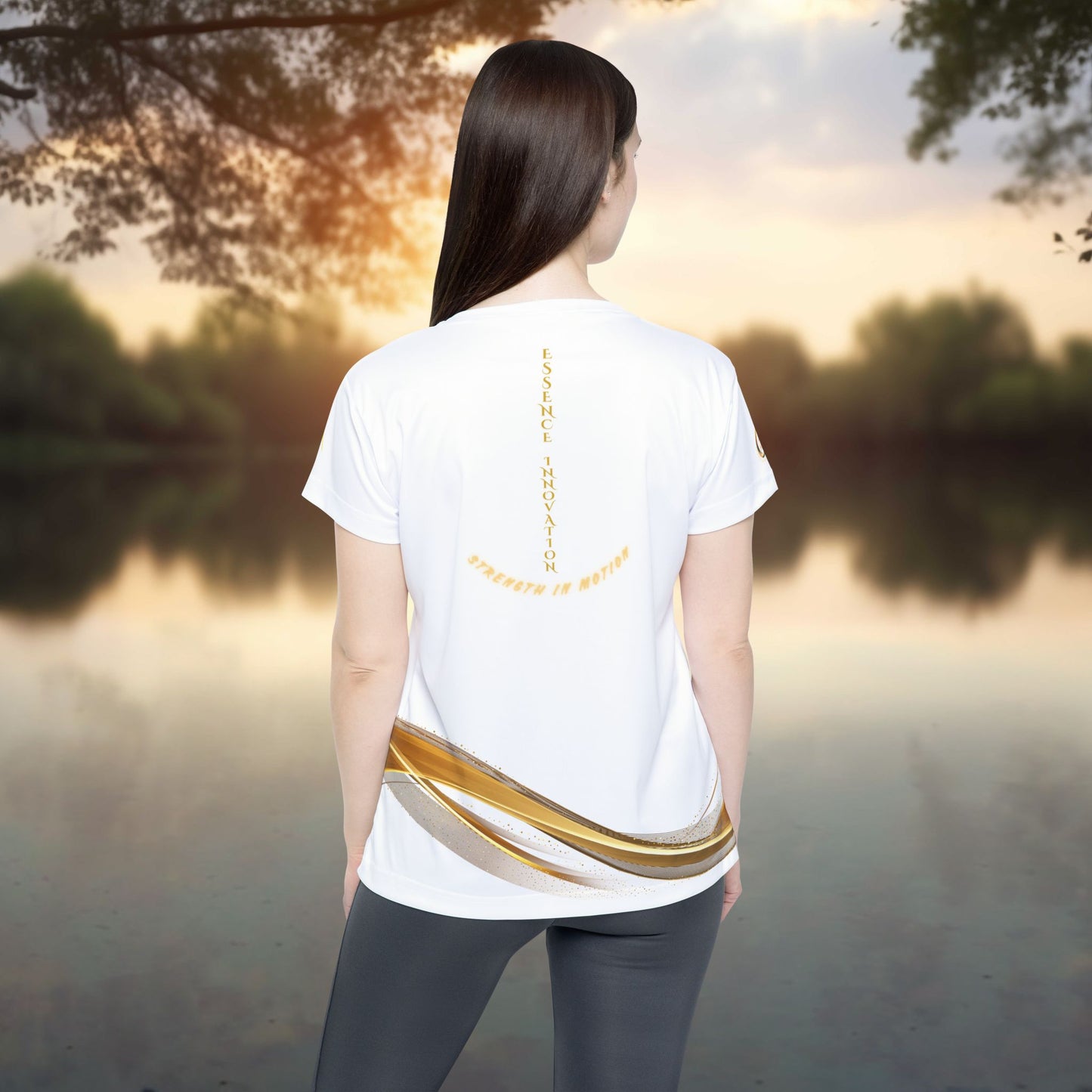 Person wearing a white t-shirt with text and design outdoors by a lake