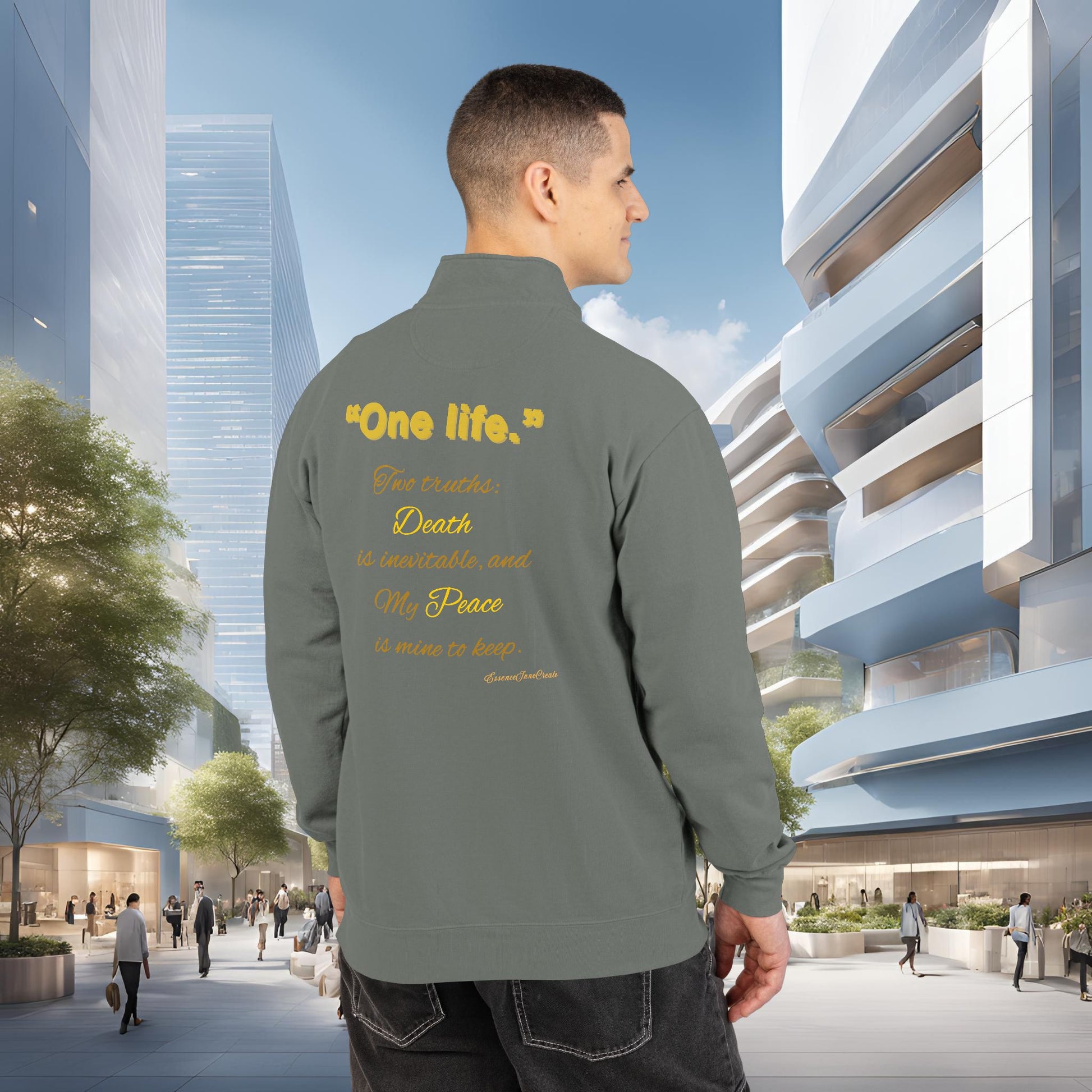 Man wearing a gray jacket with One Life text in an urban setting