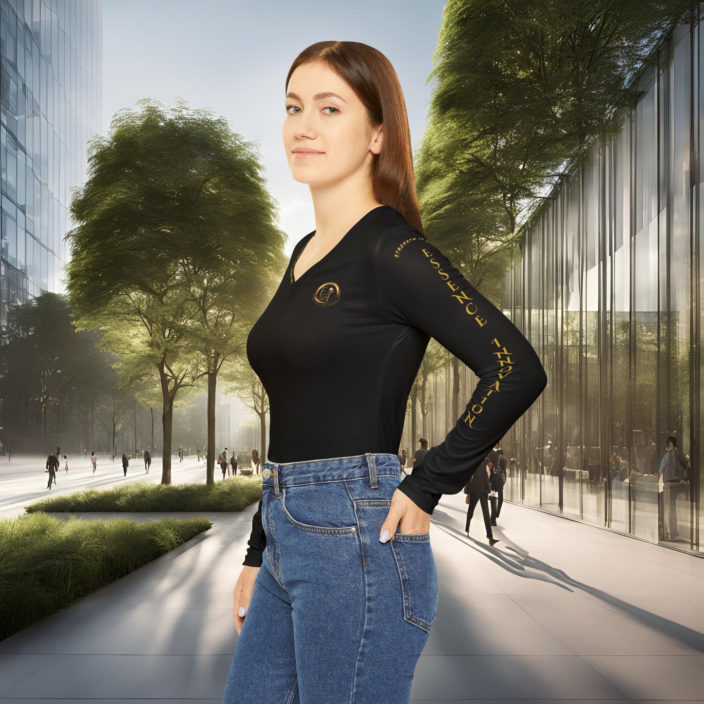 Woman in a black Essence Innovation Seek More long-sleeve top and blue jeans standing in an urban setting with trees and modern buildings.