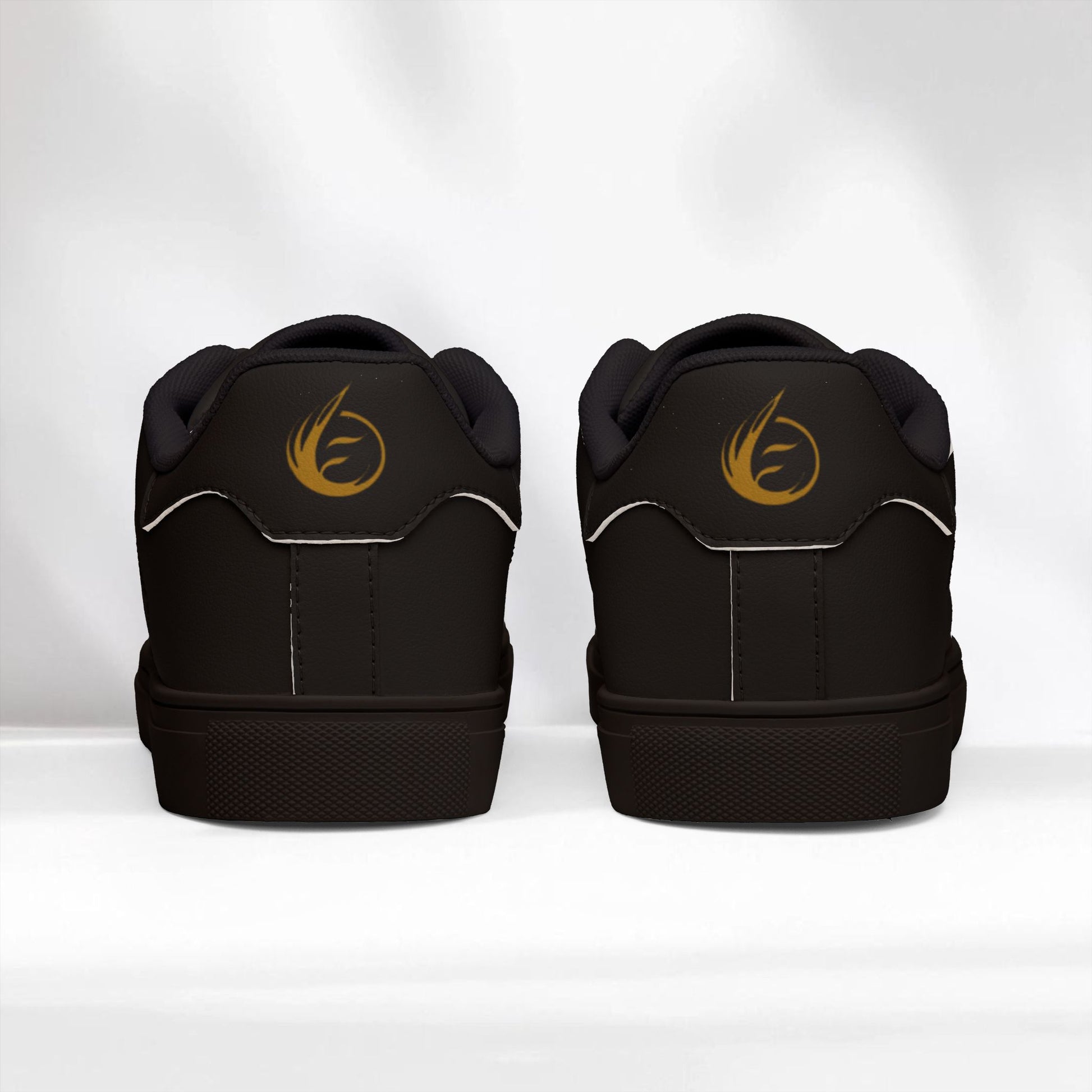 Black EssenceInnoCreate sneakers with a gold logo on a white background