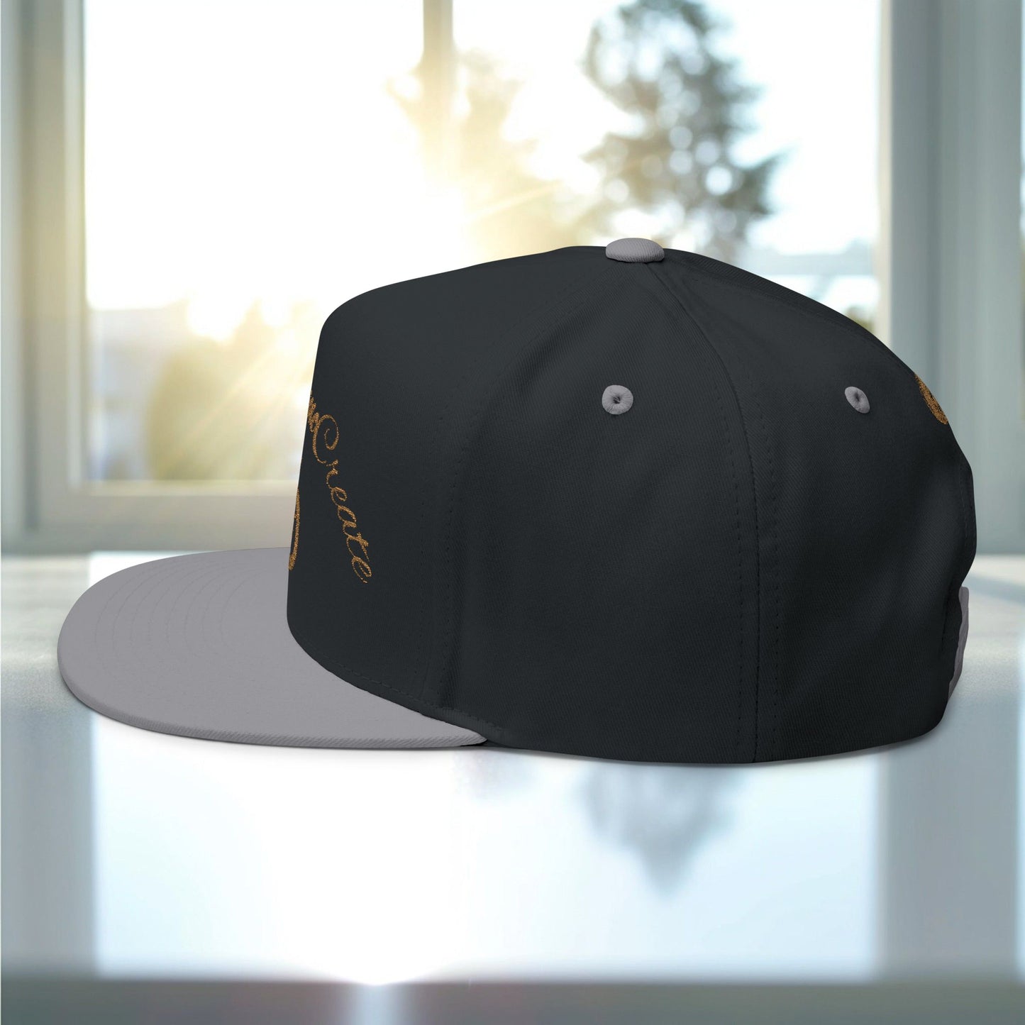 Black and gray cap with 'EssenceInnoCreate' embroidery on a reflective surface with a blurred background