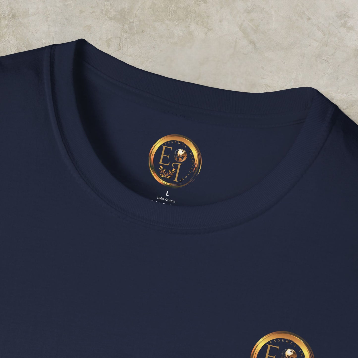 Navy blue t-shirt with a gold Essence Innovation logo on a textured beige background