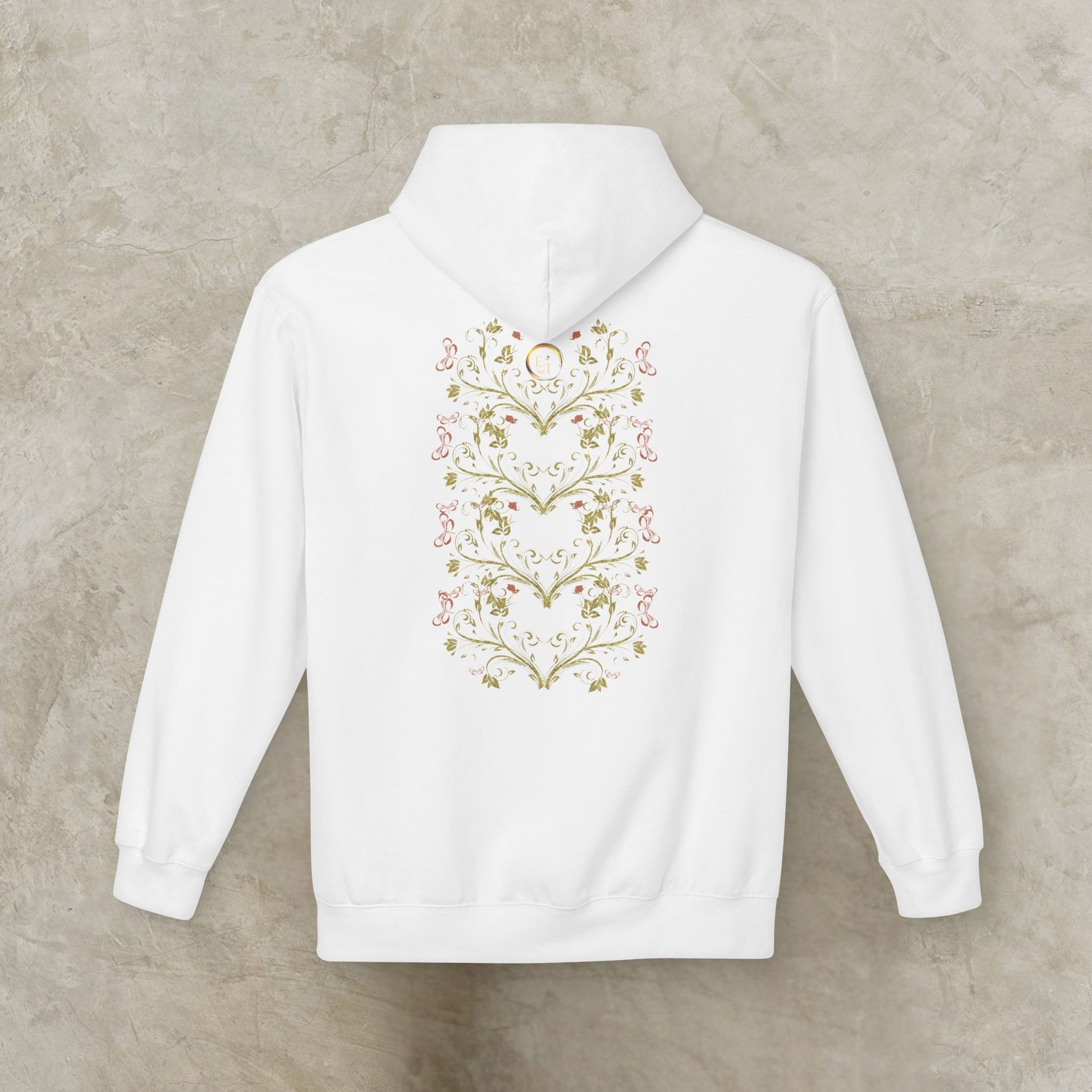 White hoodie with floral Essence Innovation Bohemian Butterfly heart design on the back against a beige background