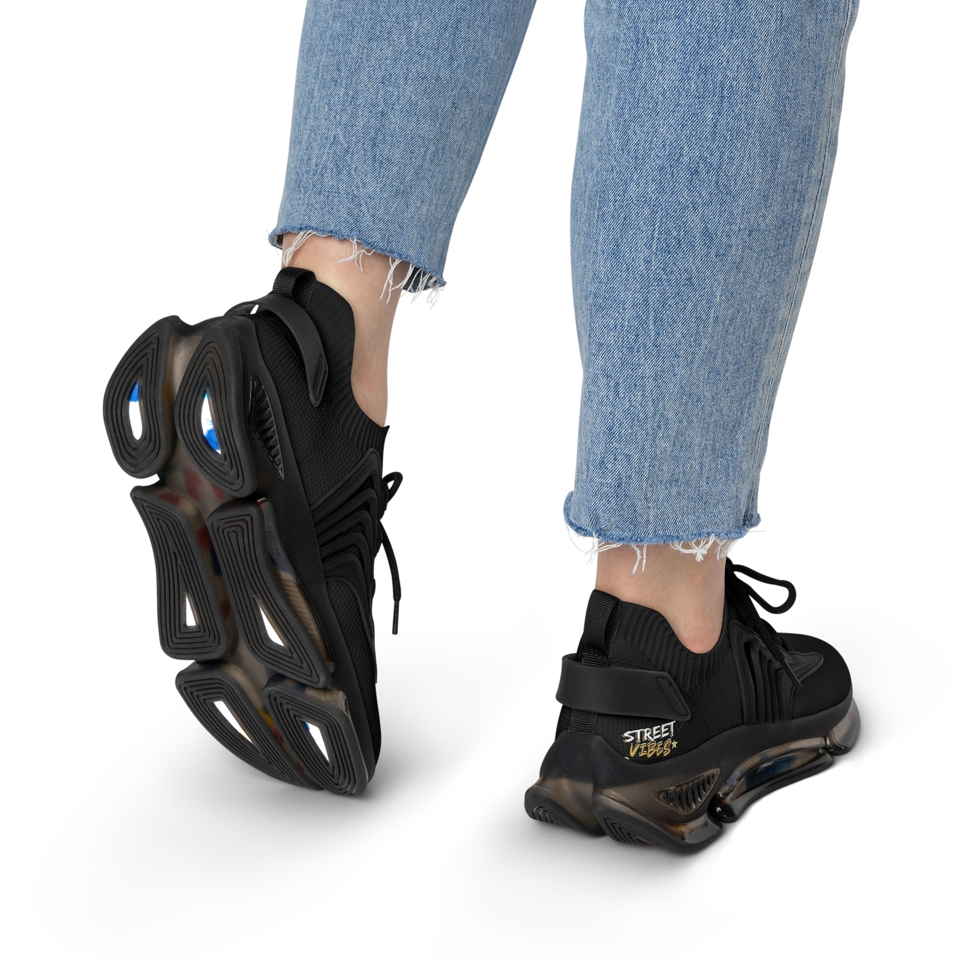 Black Essence Innovation 'Street Vibes' sneakers worn with light blue jeans on a white background