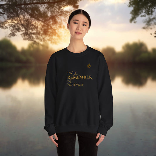 Person wearing a black EssenceInnoCreate Quiet Resolve sweatshirt with text standing by a lake at sunset
