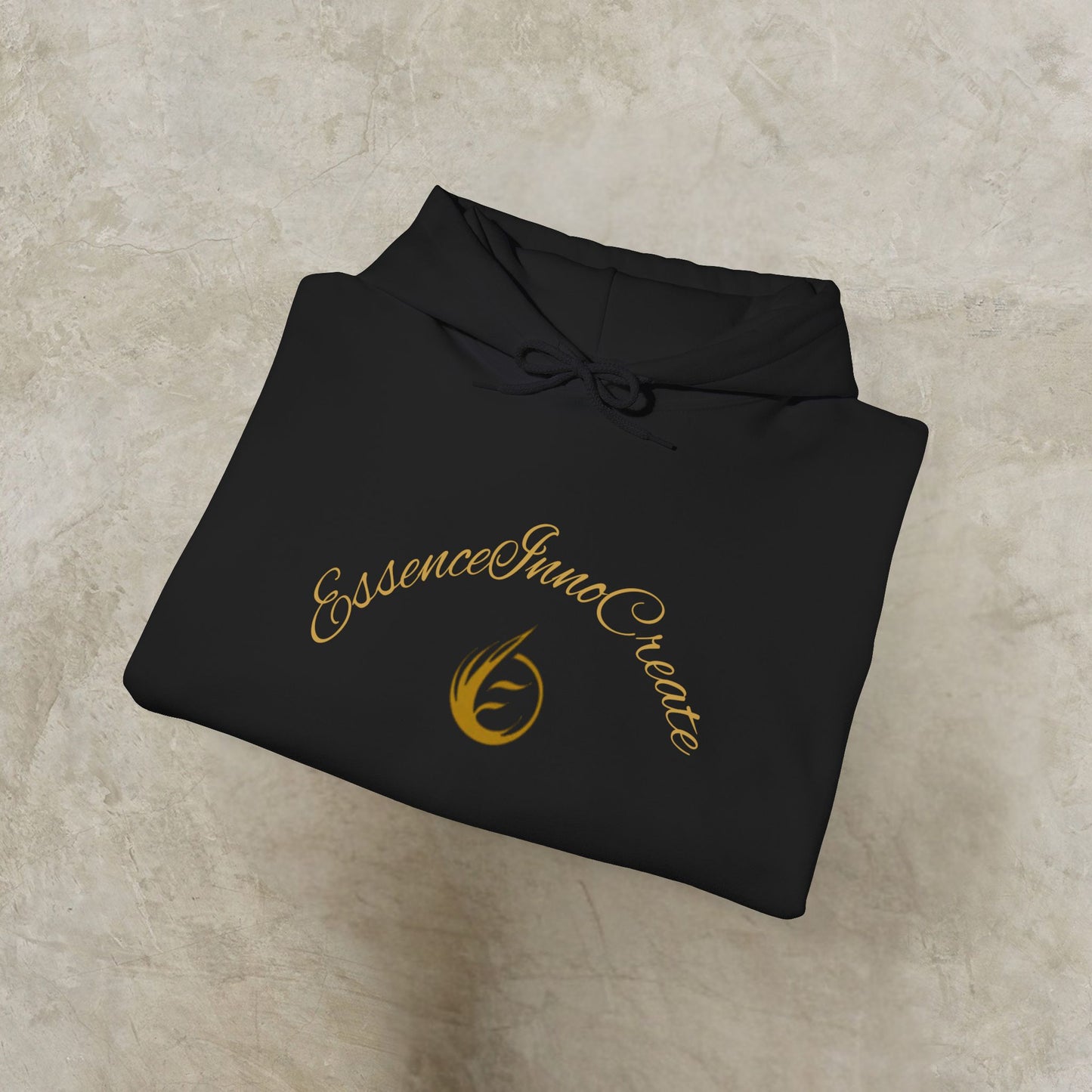 Black hoodie with gold 'EssenceInnoCreate' text and logo on a beige surface