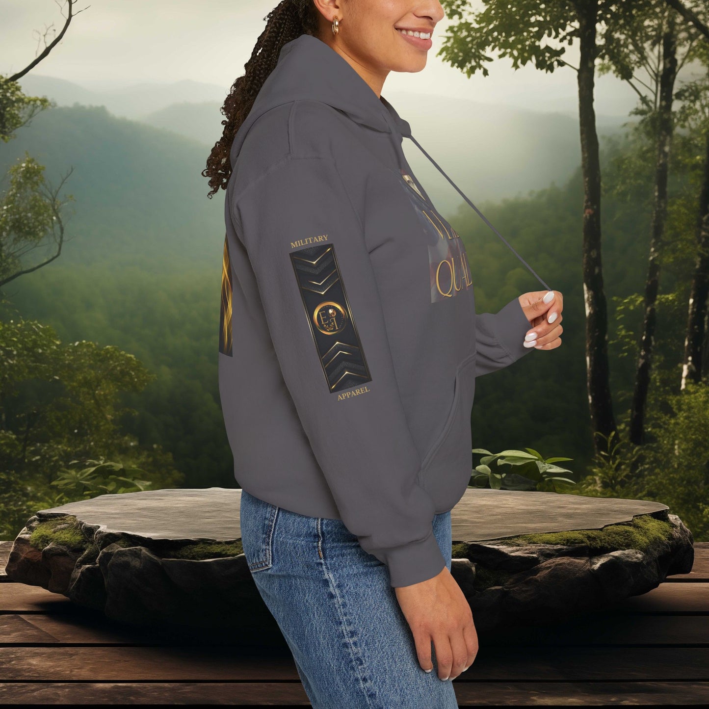 Person wearing an Essence Innovation hoodie with a scenic forest background