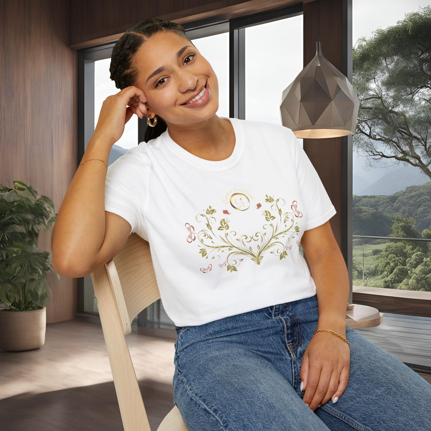 Woman wearing a white t-shirt with a Essence Innovation Bohemian Butterfly floral design sitting in a room with large windows.