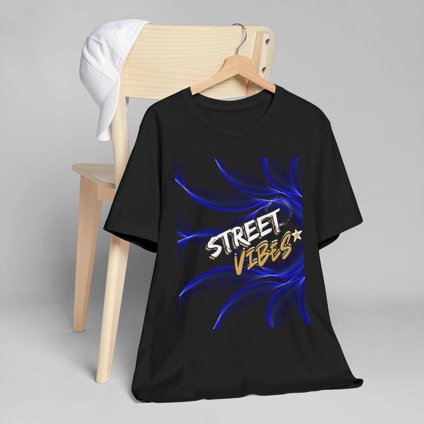 Black EssenceInnoCreate t-shirt with 'Street Vibes' design on a hanger against a gray background