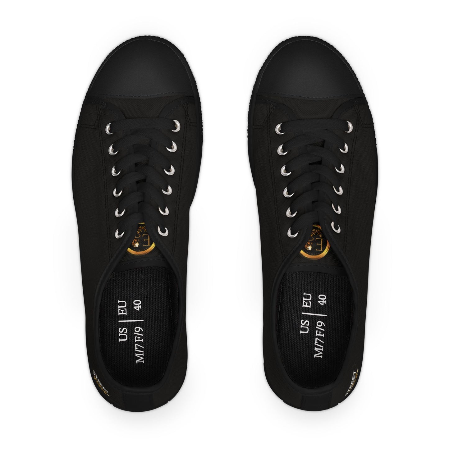 Black sneakers with gold Essence Innovation 'Street Vibes' accents on a white background