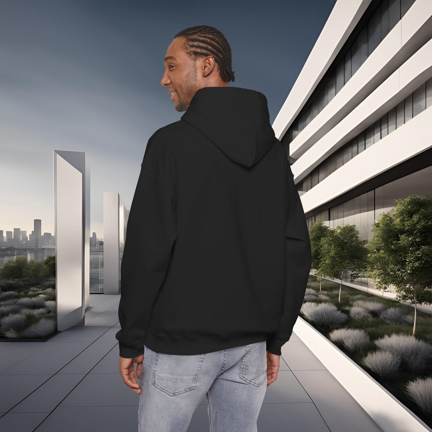 Person wearing a black 'EssenceInnoCreate' hoodie standing on a modern rooftop with cityscape in the background