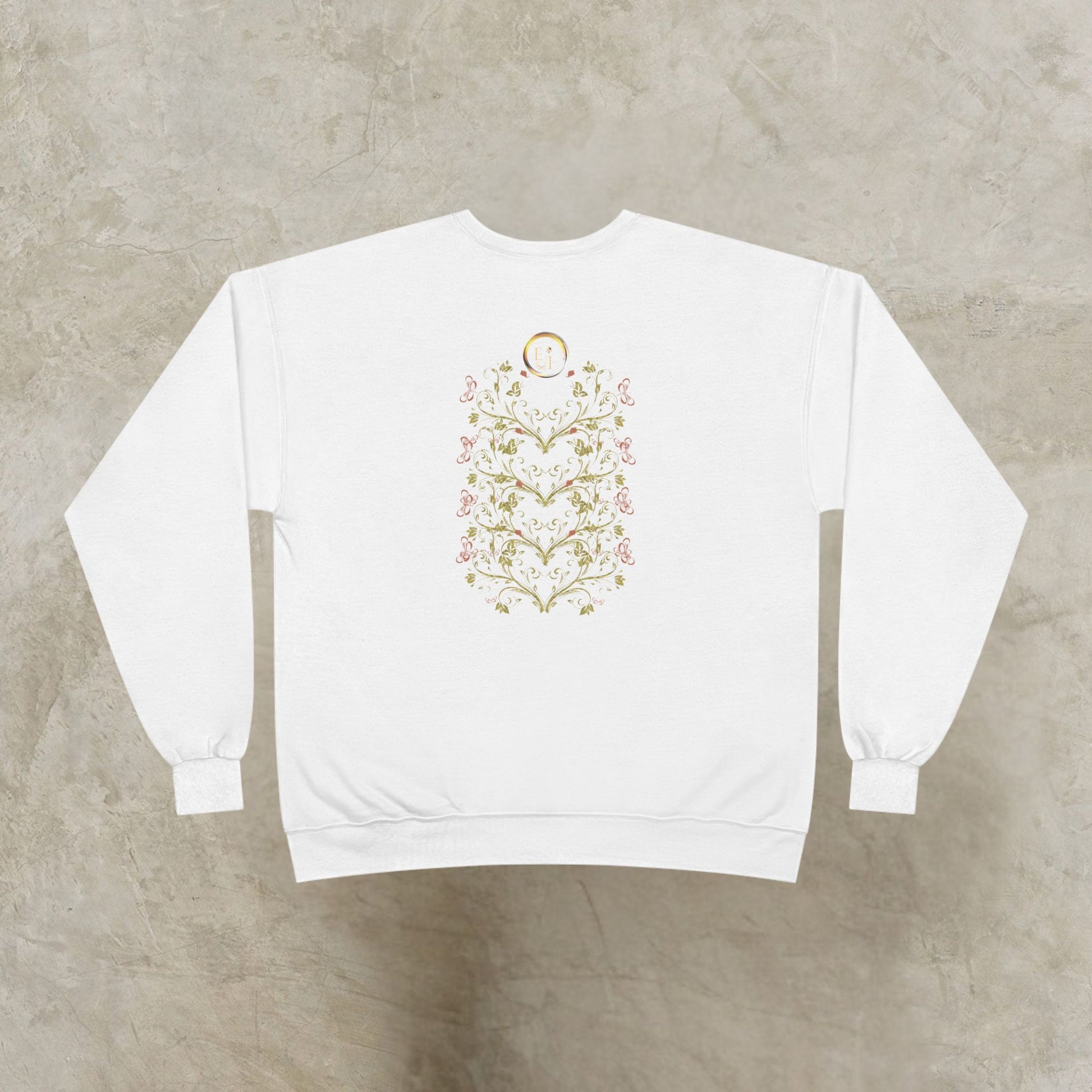 White sweatshirt with a floral Essence Innovation Bohemian Butterfly Crest design on the back against a gray background