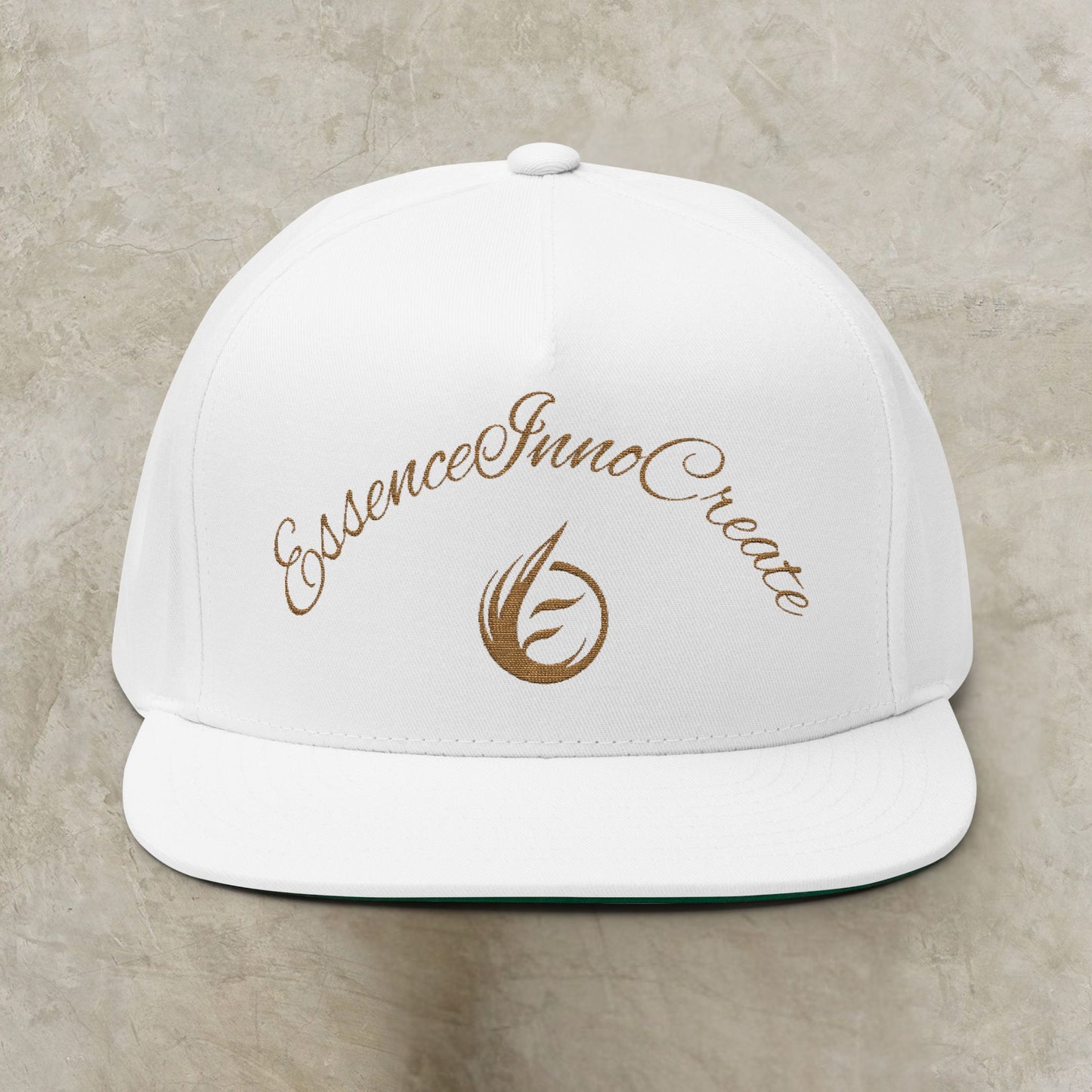 White cap with gold EssenceInnoCreate text and logo on a beige background