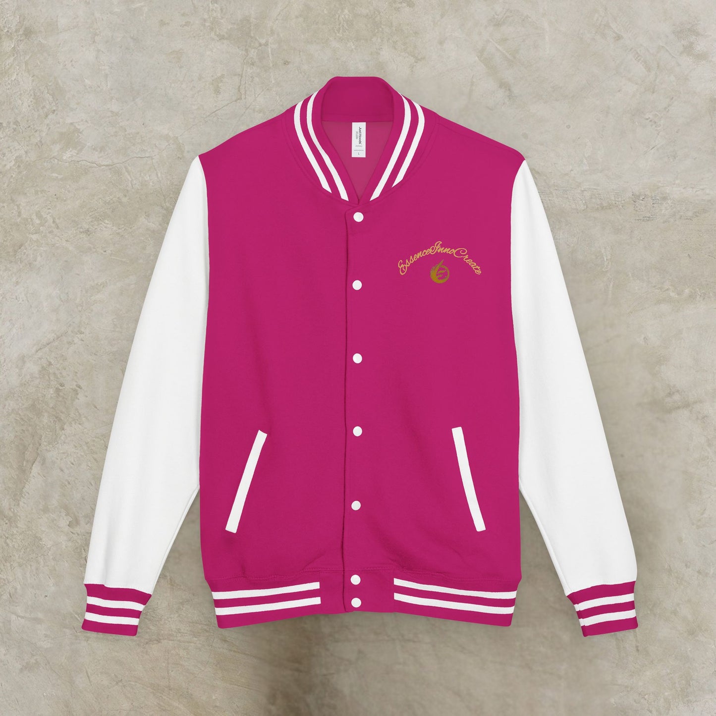 Pink and white varsity jacket with a EssenceInnoCreate logo on a gray background