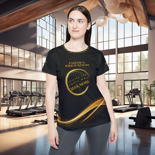 Woman wearing a black t-shirt with gold Essence Innovation Seek More text in a gym setting