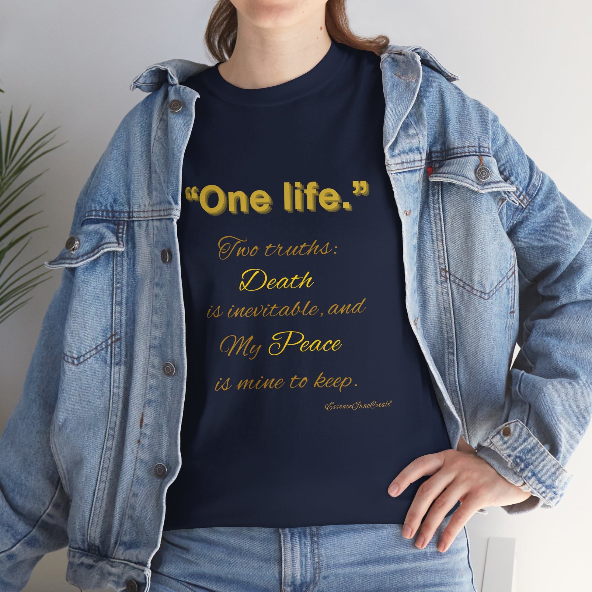 Person wearing a navy blue t-shirt with yellow One Life text and a denim jacket.