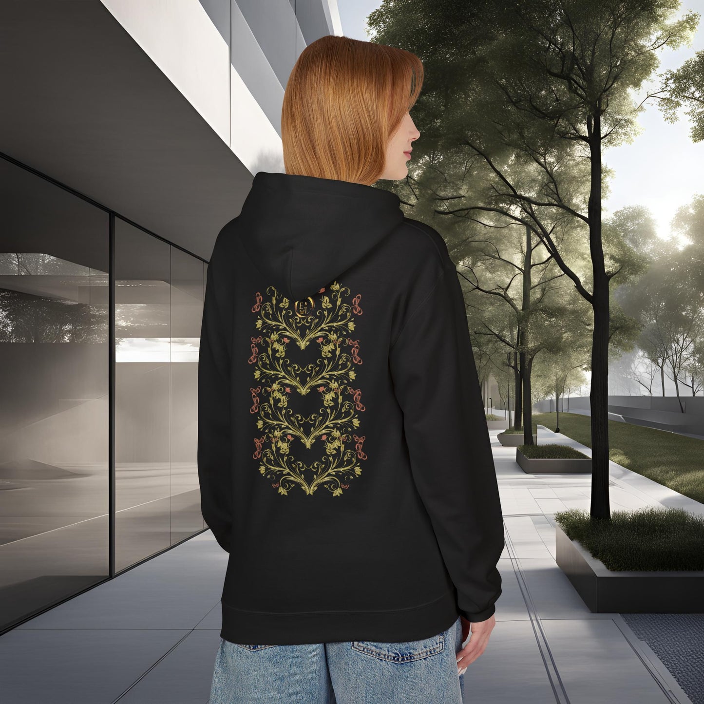 Person wearing a black hoodie with a floral Essence Innovation Bohemian Butterfly design on the back, standing in an urban setting.