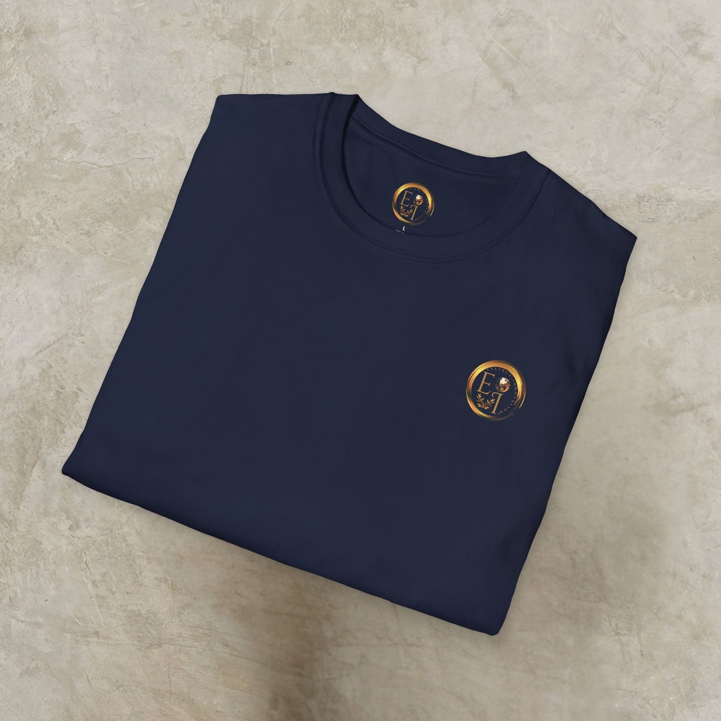 Folded navy blue t-shirt with a gold Essence Innovation emblem on a beige surface
