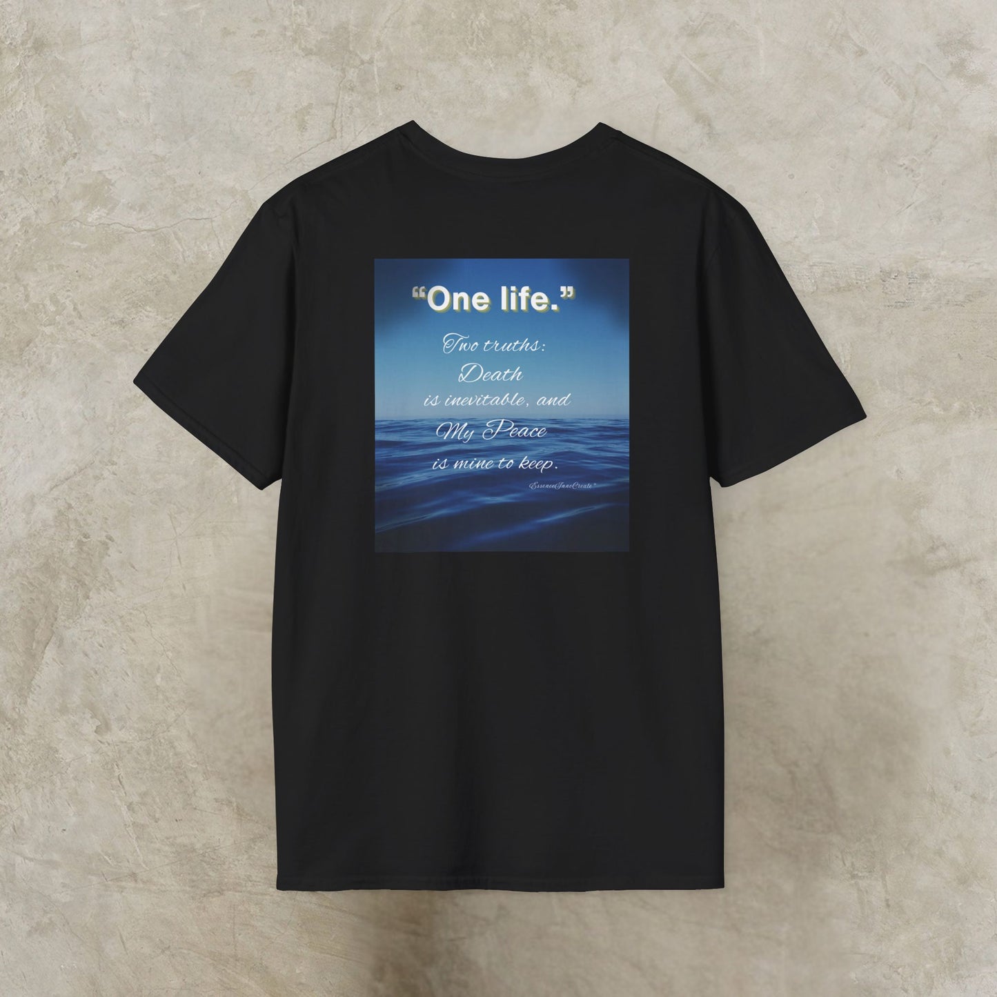 Black t-shirt with a blue graphic and One Life text on a textured beige background