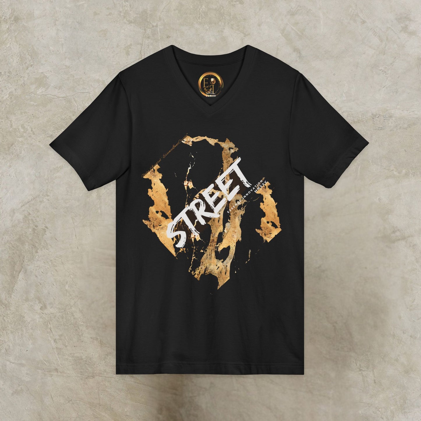Black EssenceInnoCreate t-shirt with gold and white graphic design on a textured beige background