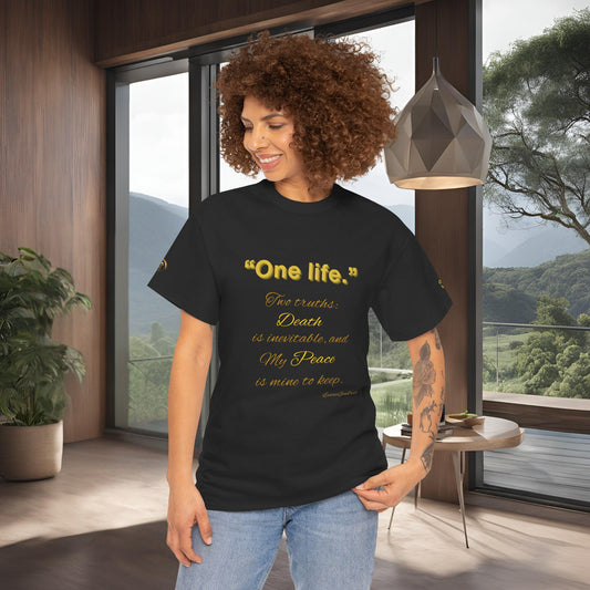 Woman wearing a black t-shirt with yellow Essence Innovation One Life text in a modern room with large windows.