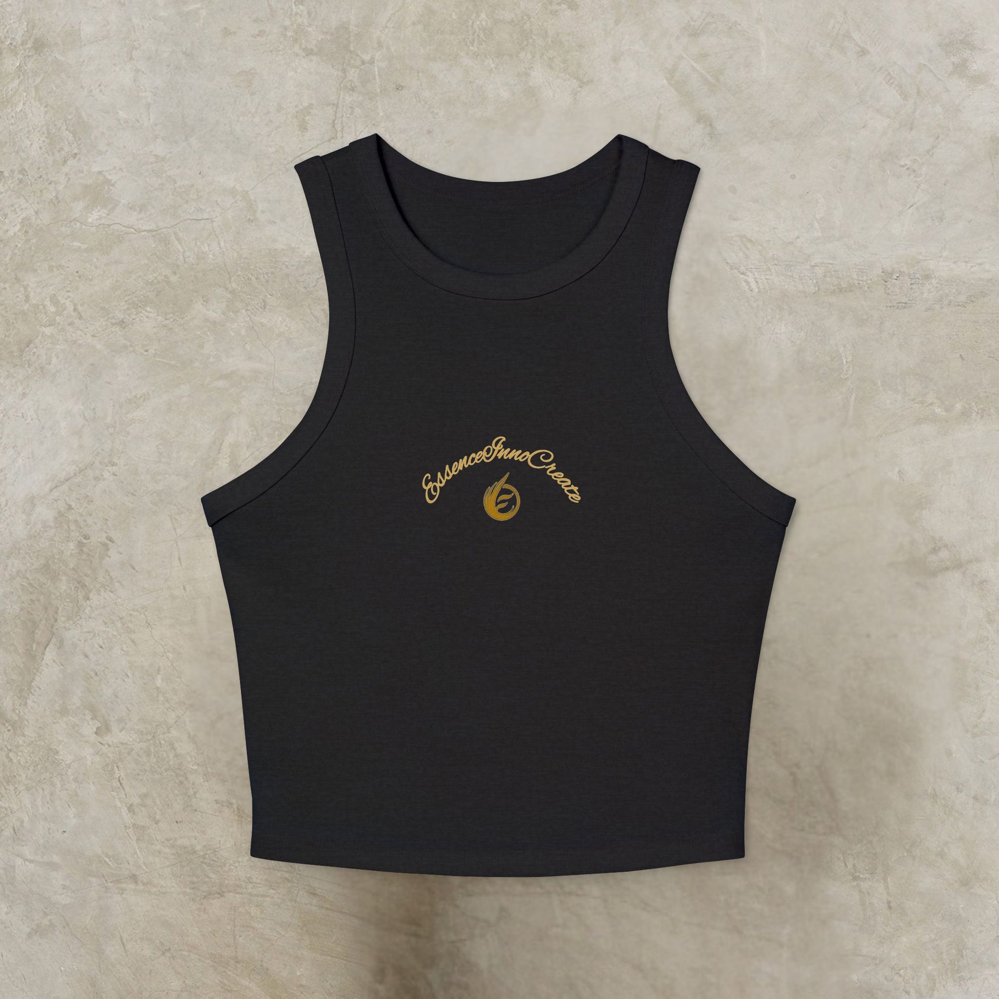 Black tank top with gold EssenceInnoCreate embroidery on a beige background