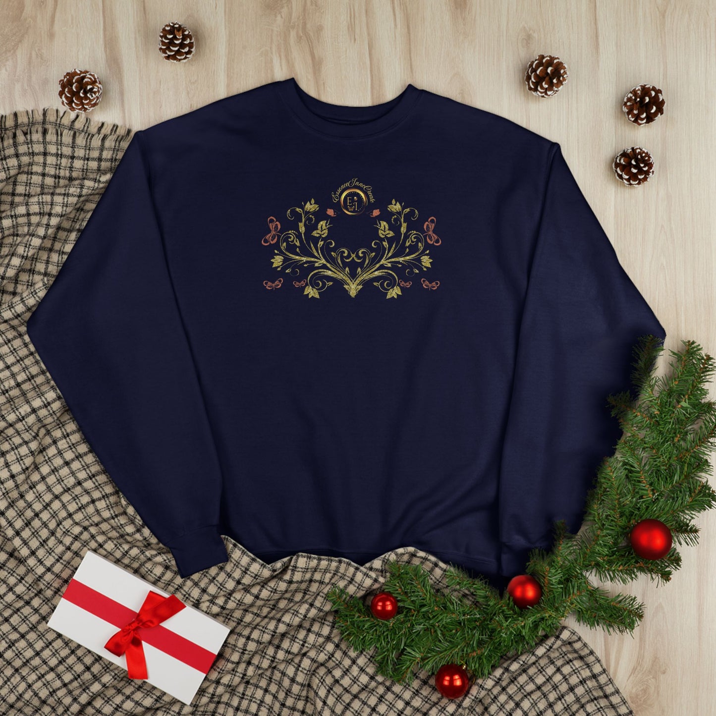 Navy blue sweatshirt with floral Essence Innovation Bohemian Butterfly Crest design on a wooden surface with Christmas decorations.