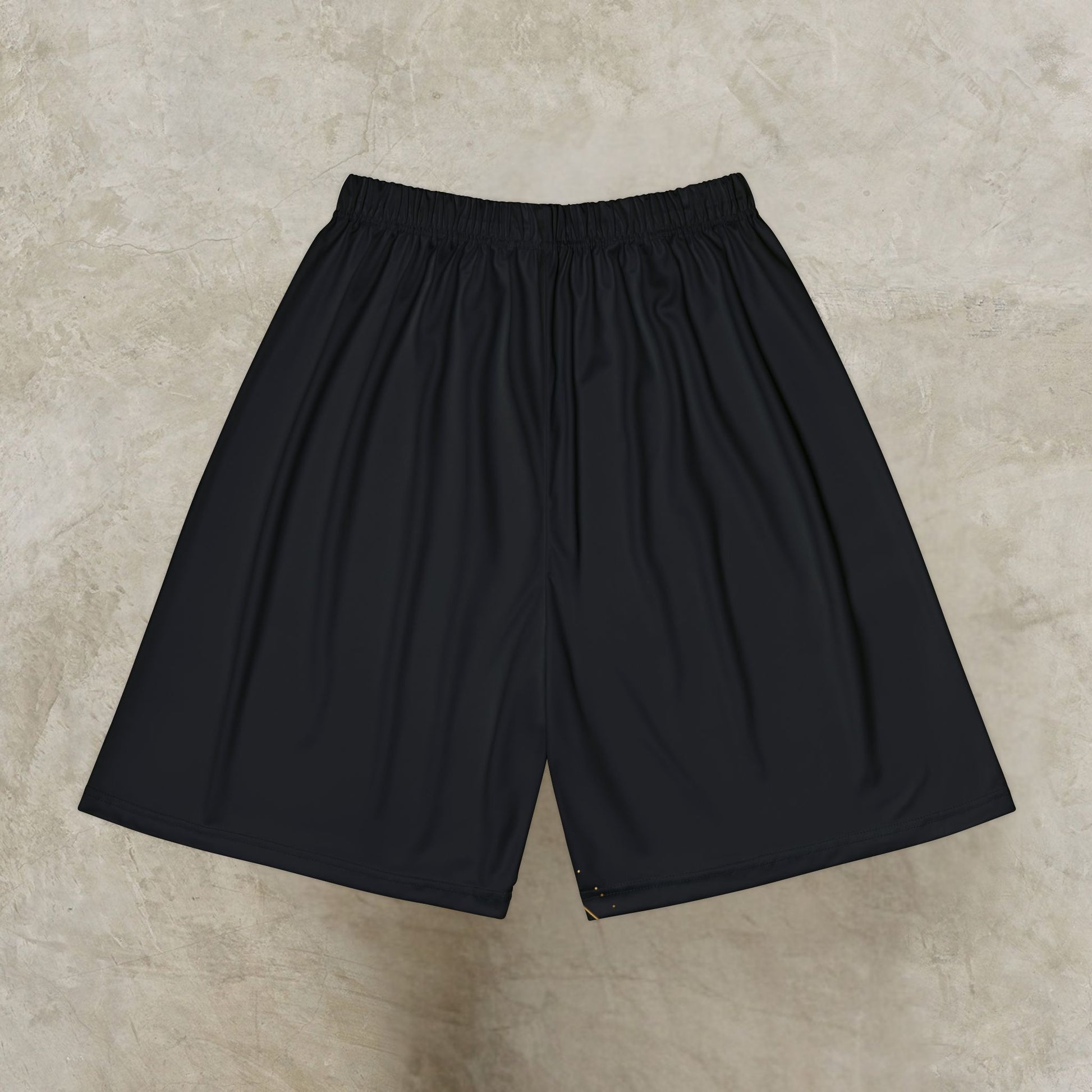 Black Essence Innovation shorts on a beige textured surface