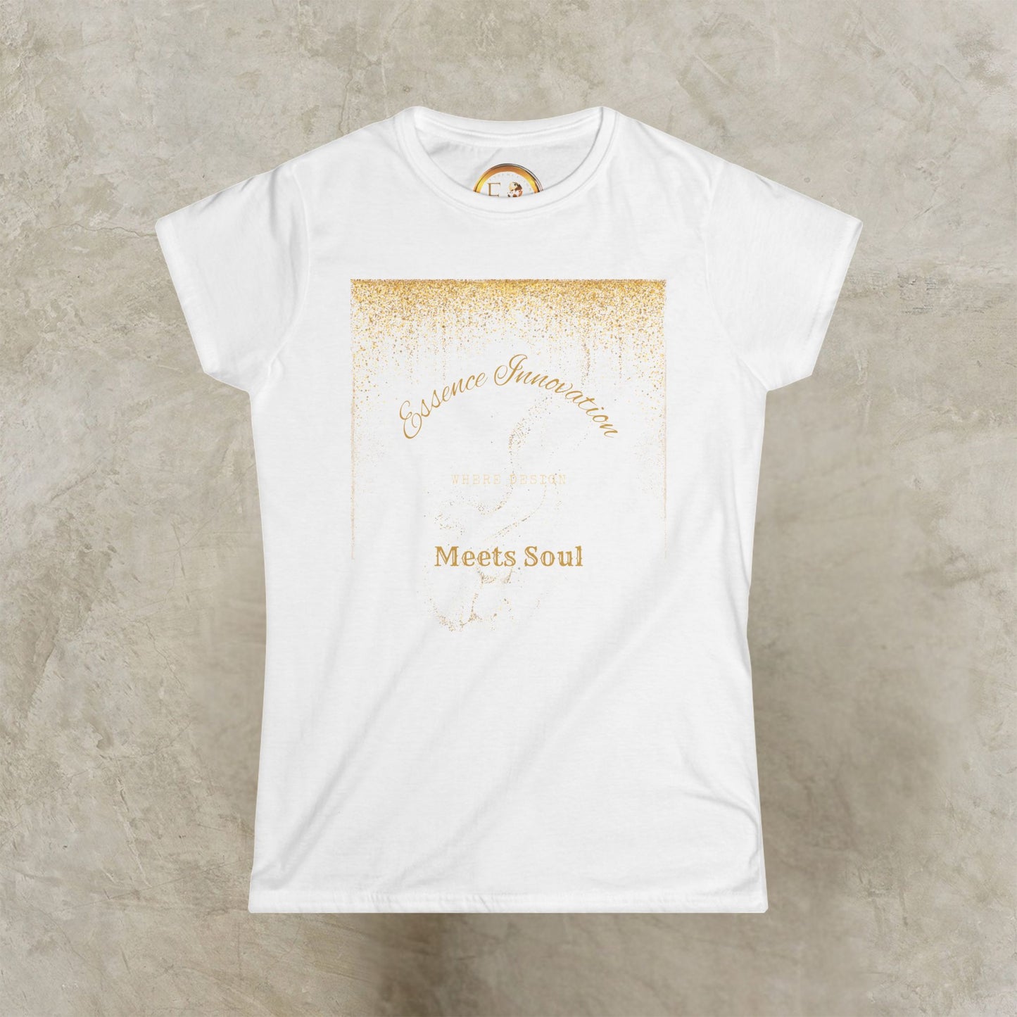 White t-shirt with gold Essence Innovation 'Design Meets Soul' text on a textured beige background