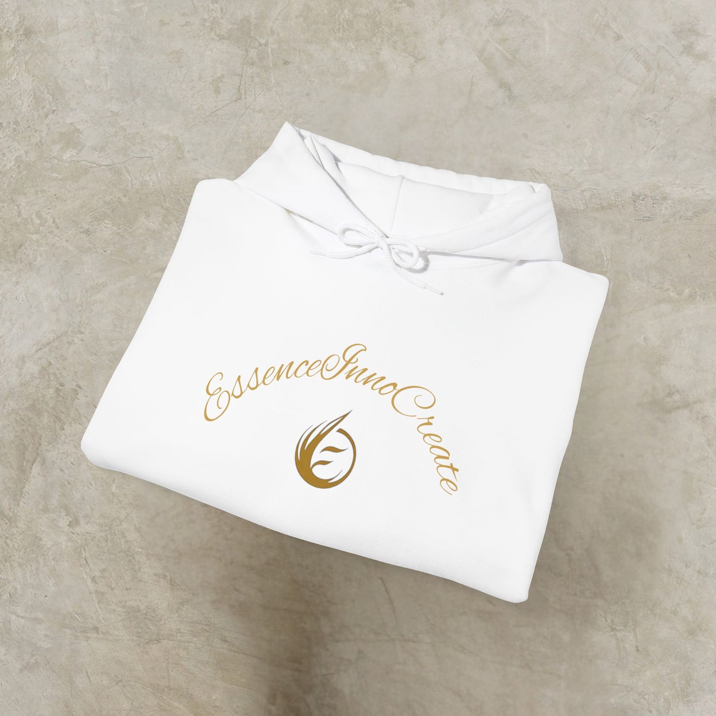 Folded white garment with 'EssenceInnoCreate' logo on a beige surface