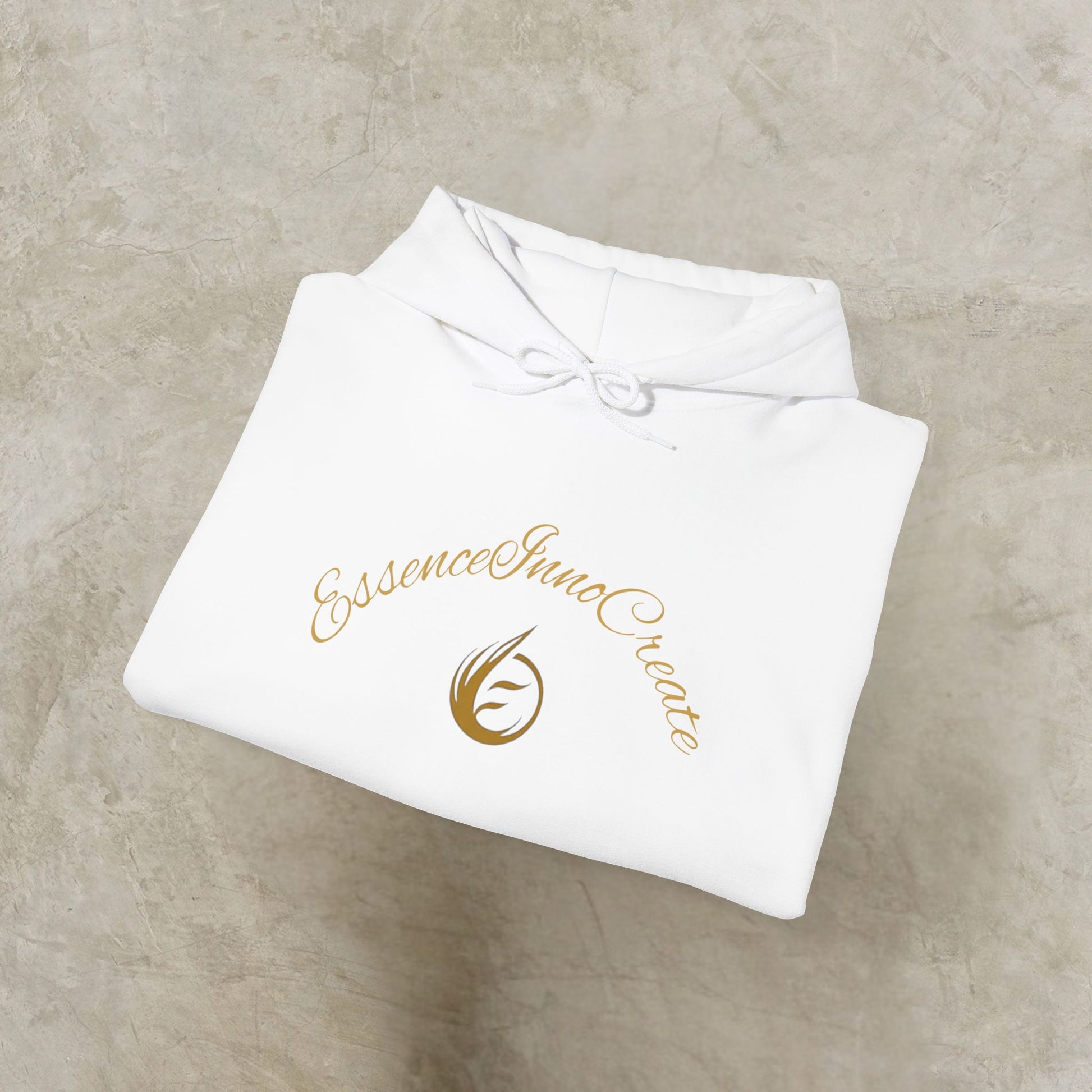 Folded white garment with 'EssenceInnoCreate' logo on a beige surface