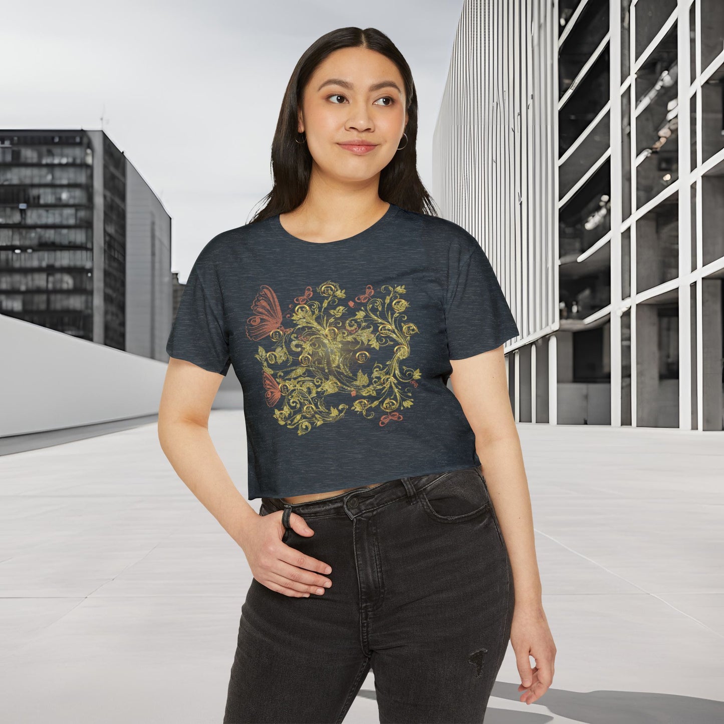 Woman wearing a dark blue t-shirt with a colorful Essence Innovation Bohemian Butterfly floral design in an urban setting.