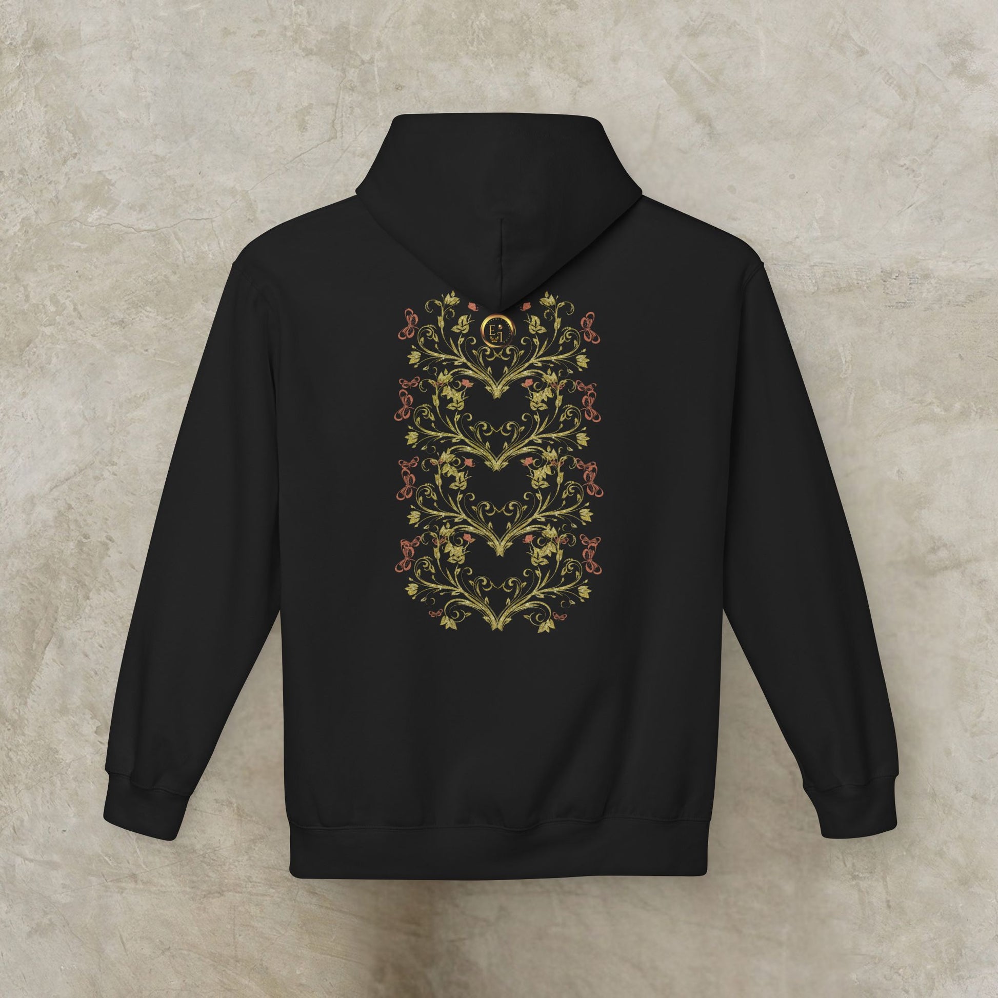 Black Essence Innovation Bohemian Butterfly hoodie with floral heart design on the back against a beige background