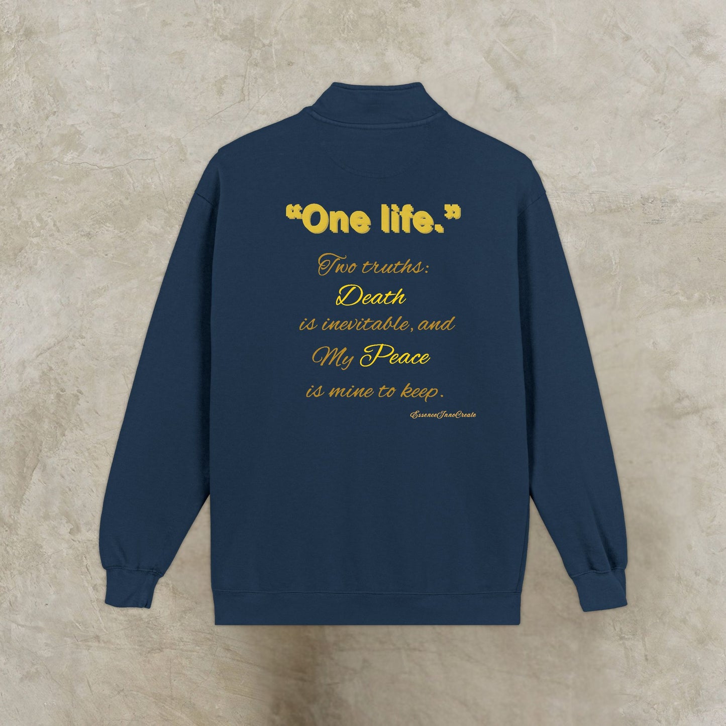 Navy blue sweatshirt with yellow One Life text on a beige background