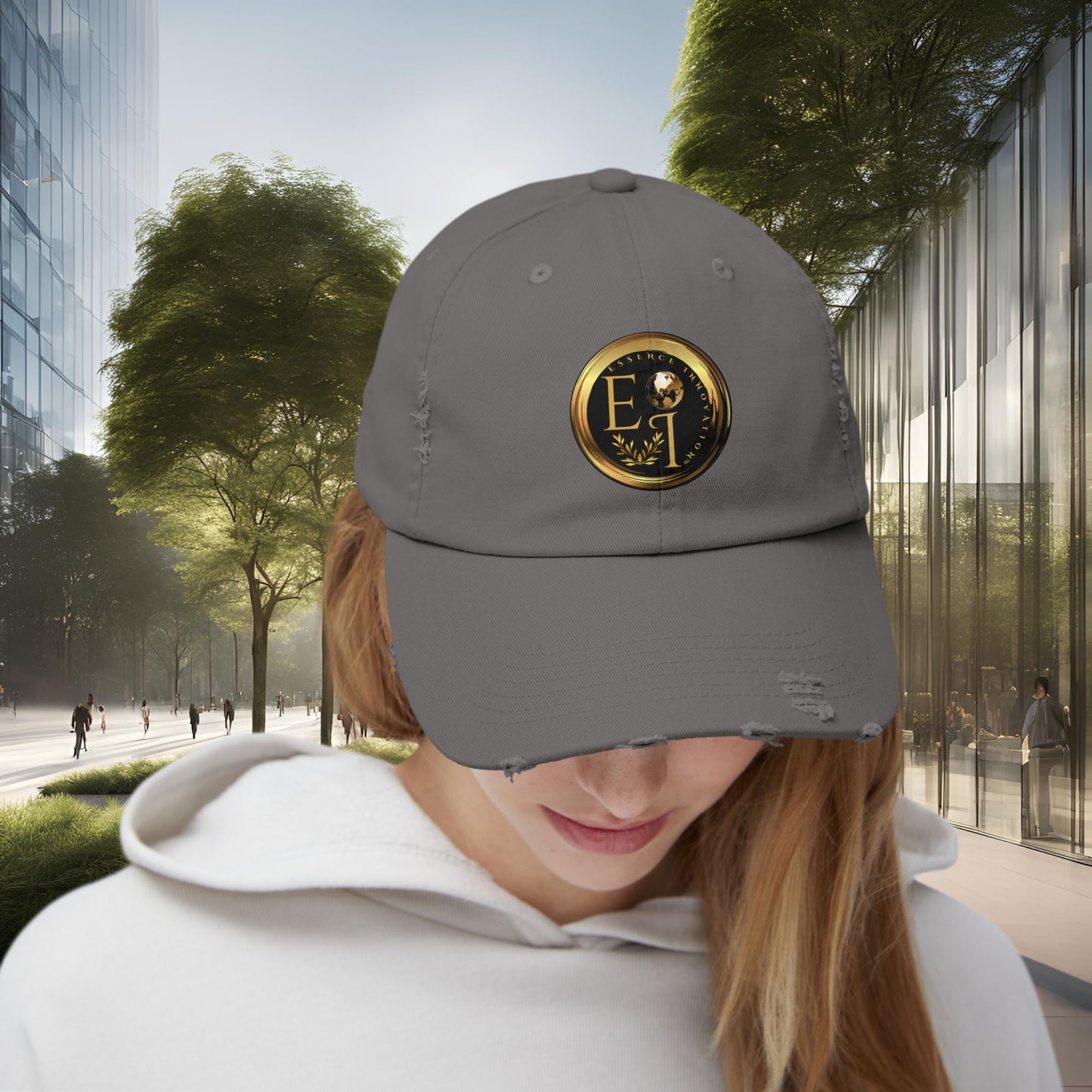 Person wearing a gray Essence Innovation cap with a logo in an urban setting