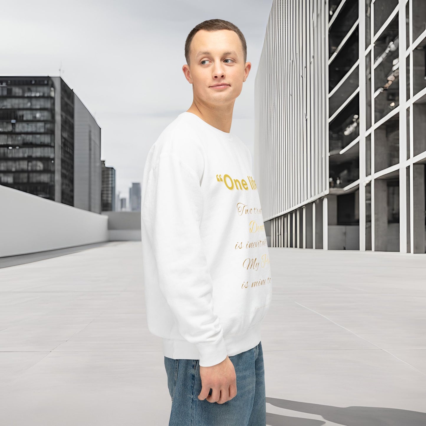 Man wearing a white sweatshirt with text standing on a rooftop with cityscape background